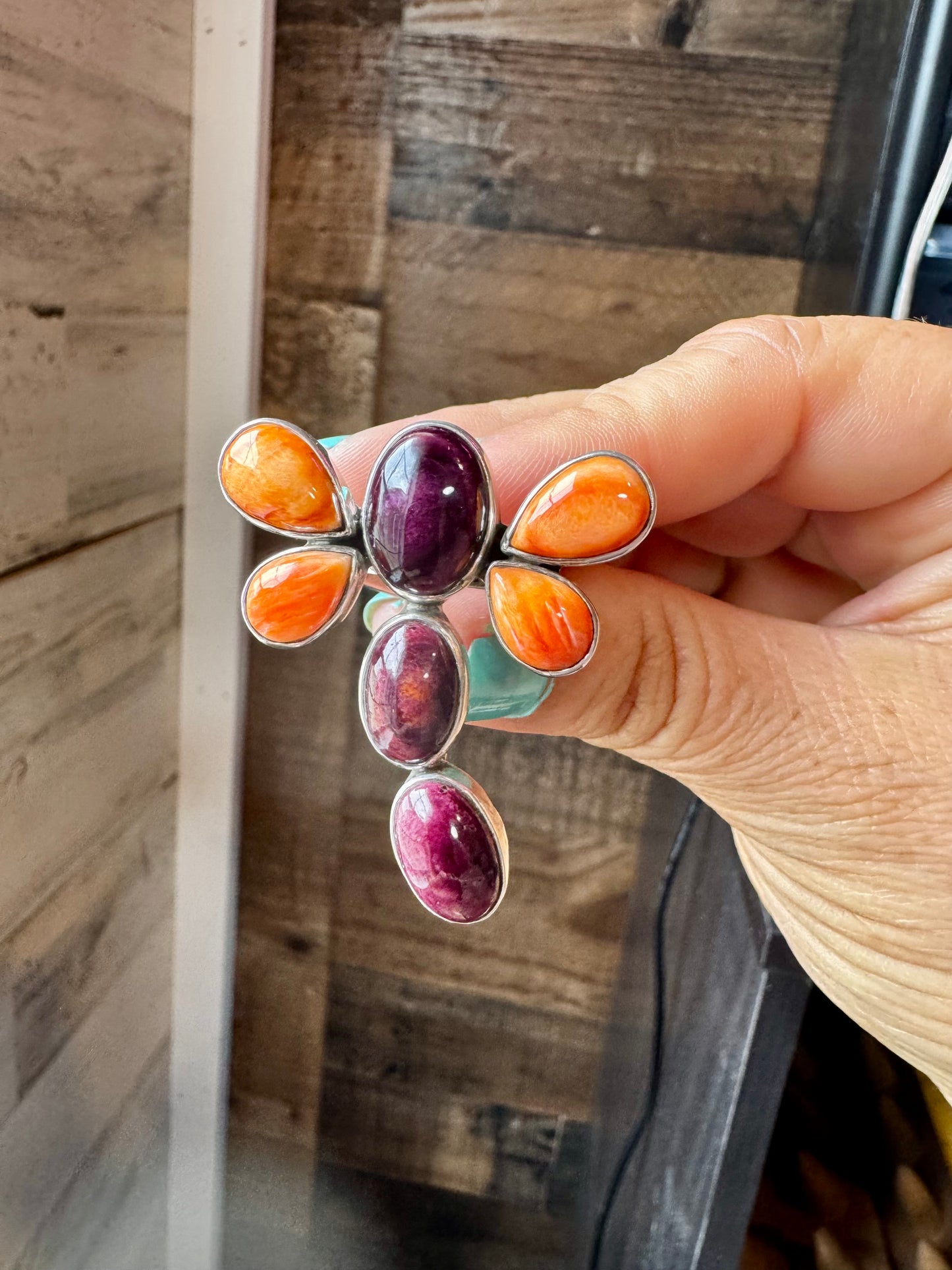 Handcrafted sterling silver dragonfly ring featuring purple and orange spiny oyster stones. Stamped ZIA and made in the USA. Adjustable fit and full of playful personality. Curated by The Bijoux FAB.