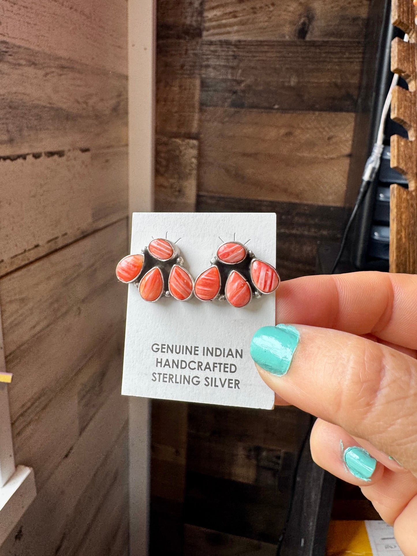 Handcrafted sterling silver stud earrings featuring vibrant spiny oyster shell, stamped by artist Marcella James. Made in the USA. One-of-a-kind design. Curated by The Bijoux FAB.