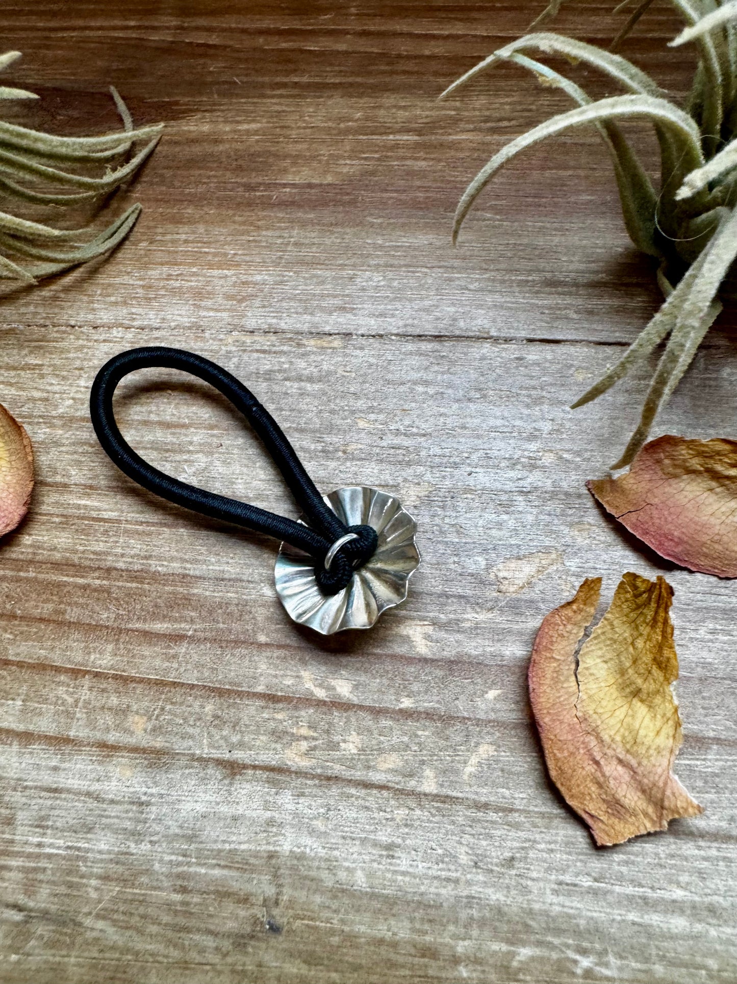 Small sterling silver hair tie featuring a hand-stamped concho design. Lightweight, durable, and stamped STERLING. Handmade in the USA. Each pattern is slightly different. Curated by The Bijoux FAB.