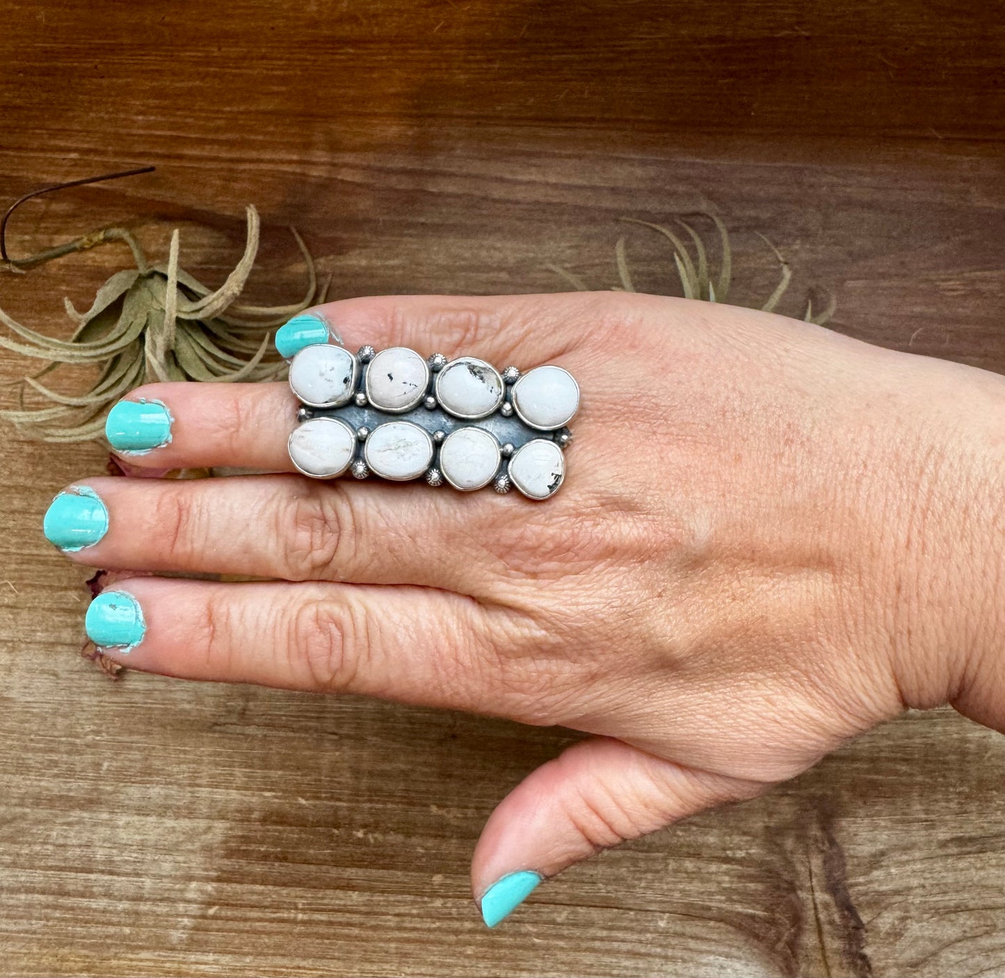 Adjustable long statement ring featuring eight genuine White Buffalo turquoise stones set in solid sterling silver with a detailed band. Stamped ZIA. Handmade in the USA. One-of-a-kind and curated by The Bijoux FAB.