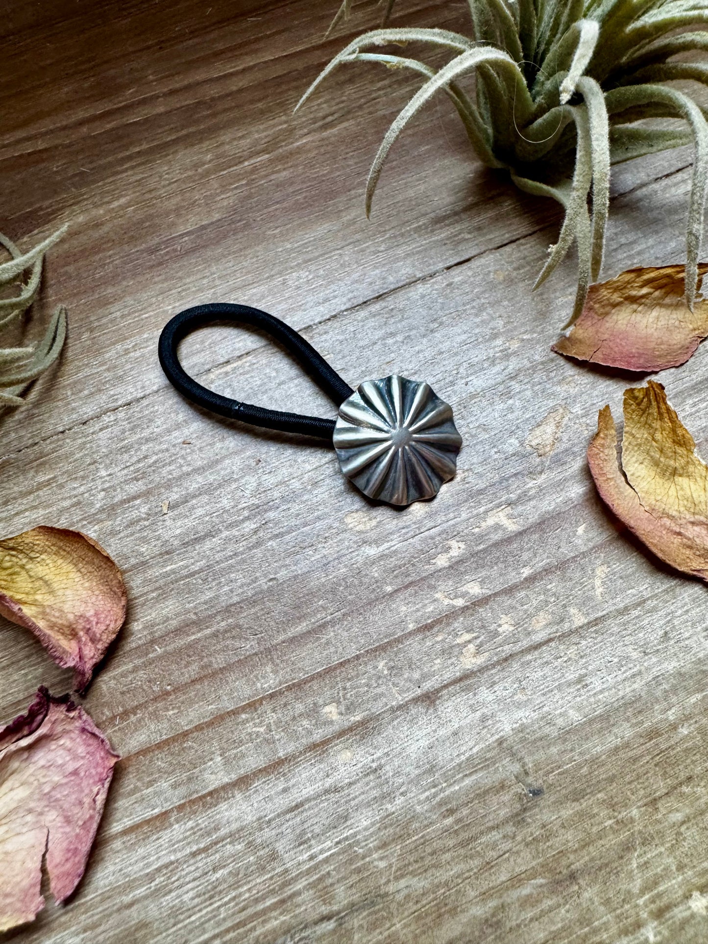 Small sterling silver hair tie featuring a hand-stamped concho design. Lightweight, durable, and stamped STERLING. Handmade in the USA. Each pattern is slightly different. Curated by The Bijoux FAB.