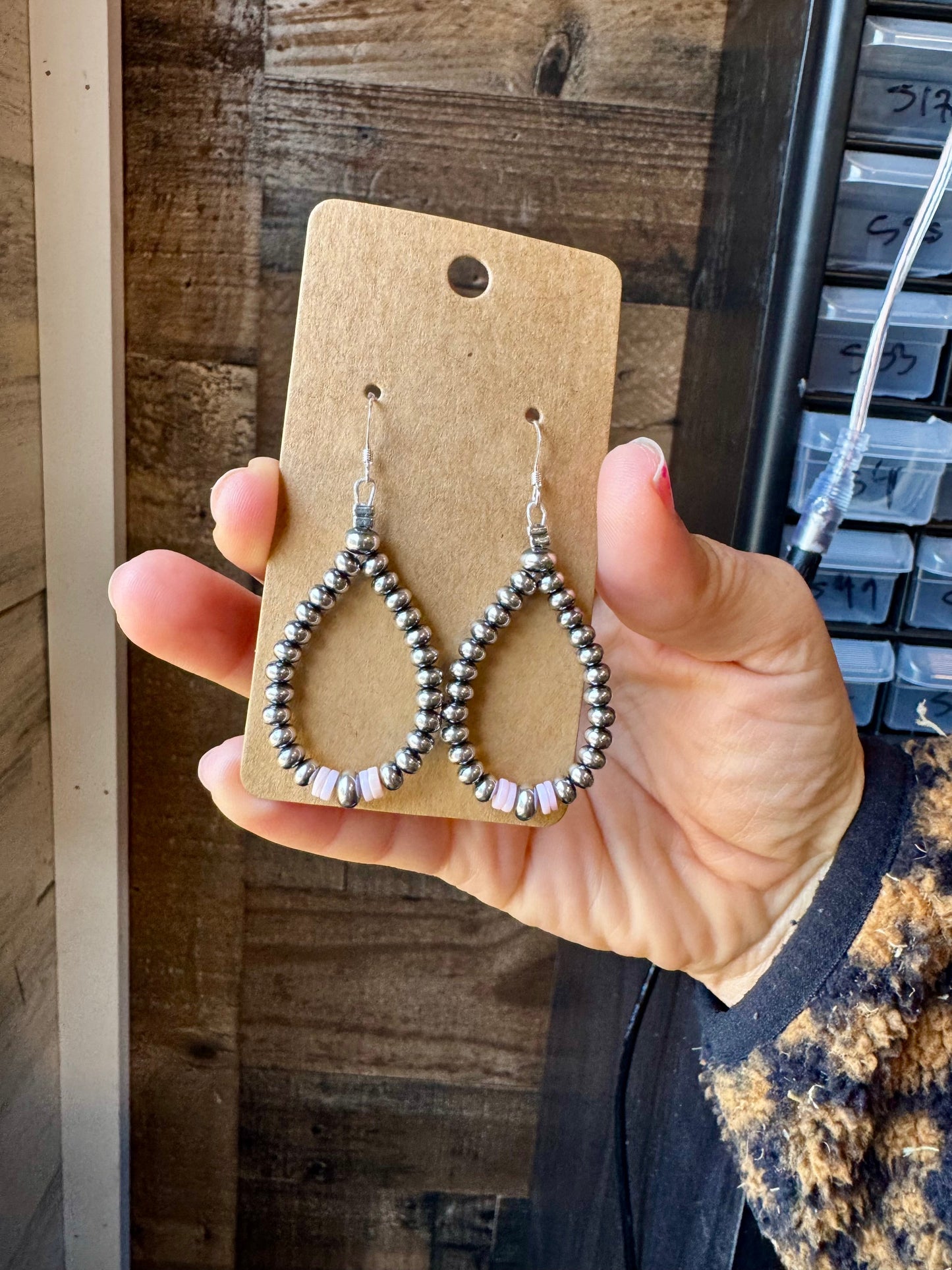 2.5-inch handmade dangle earrings featuring 4mm, 5mm, and 6mm saucer sterling silver pearls with Pink Conch Heishi accents. Includes .925 sterling silver hooks. Each pink conch shade is slightly unique. Lightweight and made in the USA by The Bijoux FAB.