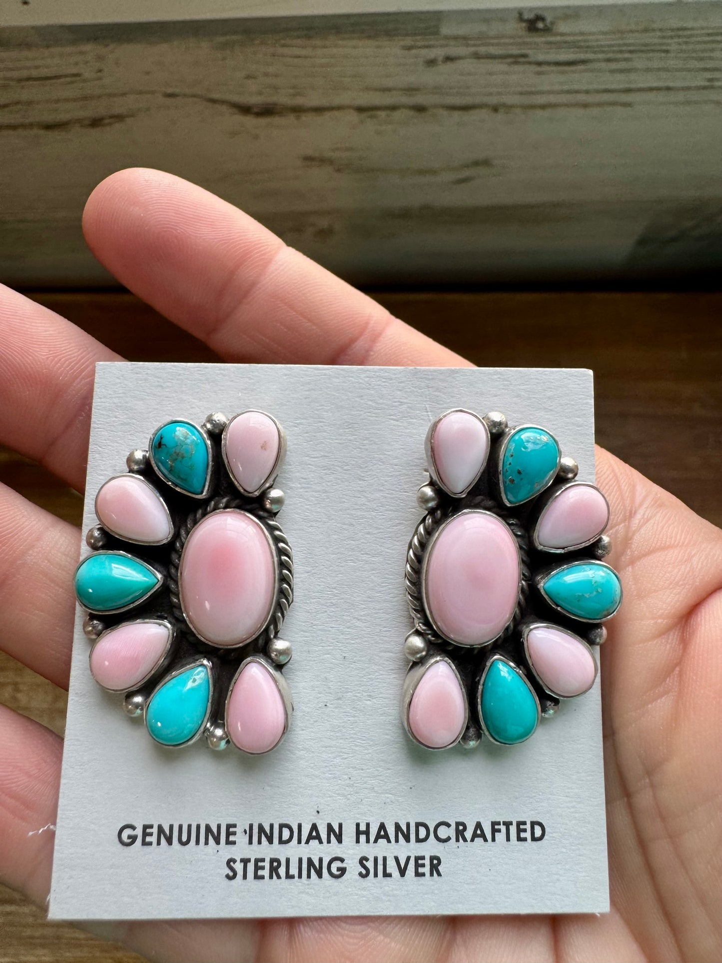 Handcrafted half cluster earrings with a dominant pink conch center surrounded by Kingman turquoise in a “Cotton Candy” color combo. Set in sterling silver, stamped E. Richards. Post backs placed at the top. Made in the USA. Each pair is one of a kind. Curated by The Bijoux FAB.