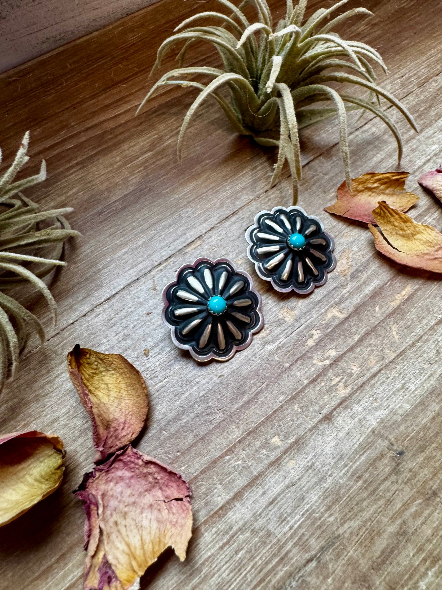 Large handcrafted concho stud earrings featuring genuine turquoise stones set in detailed sterling silver. Made in the USA. Lightweight and naturally unique. Curated by The Bijoux FAB.