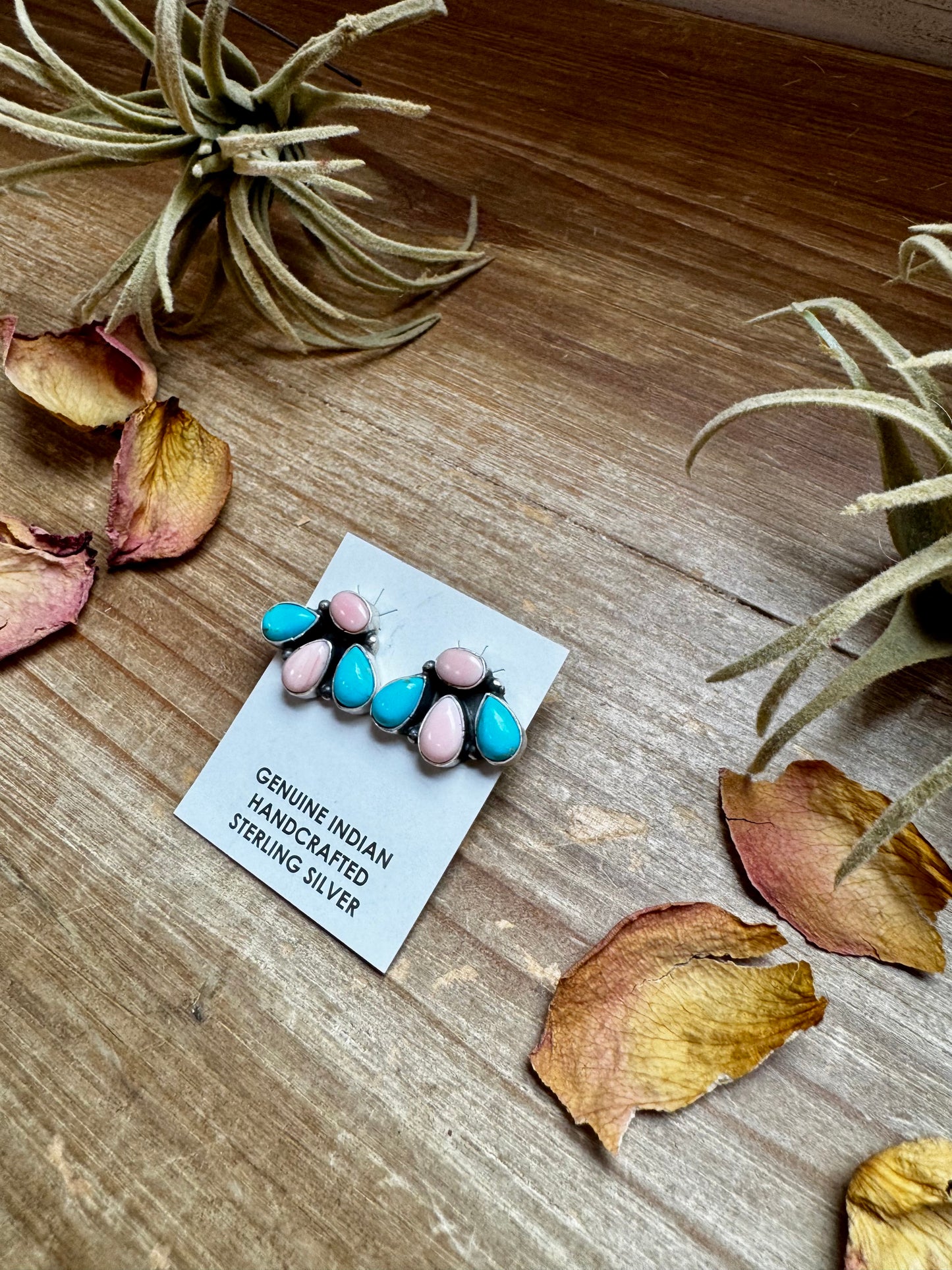 Handcrafted sterling silver stud earrings featuring genuine Kingman turquoise and pink conch stones. Stamped by artist Marcella James. Made in the USA. Each pair is naturally unique. Curated by The Bijoux FAB.