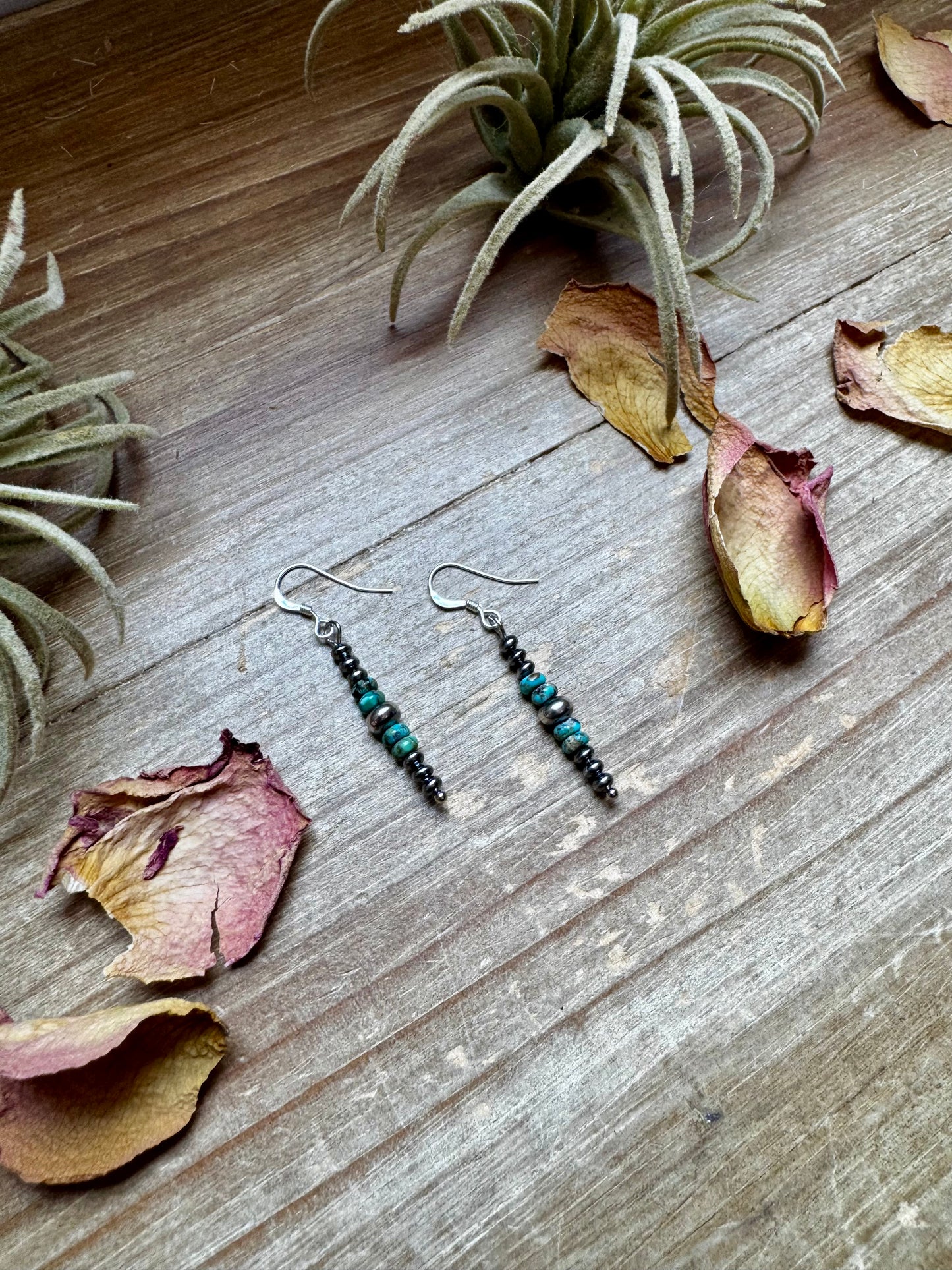 Close-up of handmade turquoise rondelle earrings with sterling silver beads and hooks, under 1.5 inches long