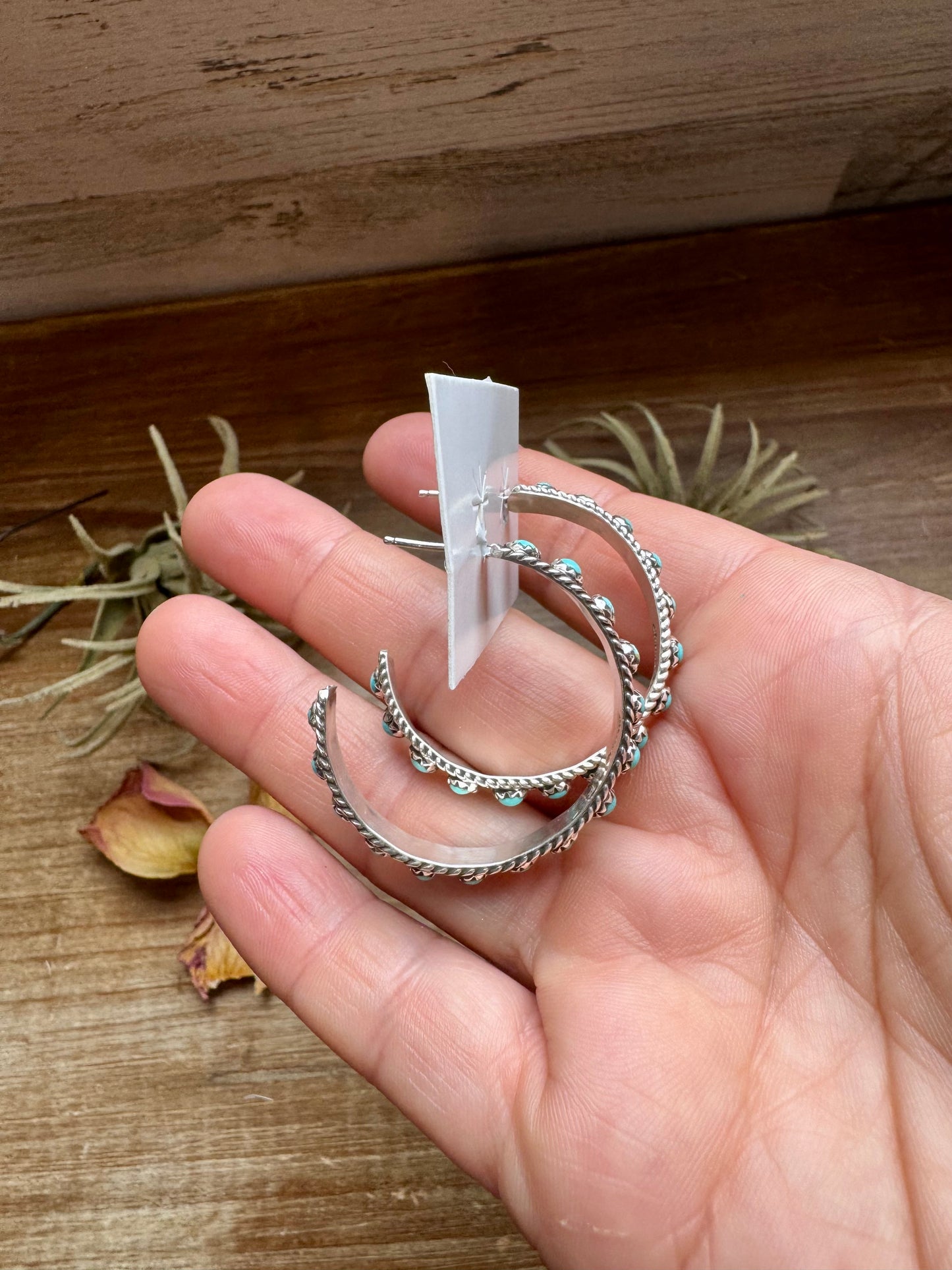 Handcrafted Snake Eye hoop earrings featuring rows of genuine Kingman turquoise stones set in solid sterling silver. Stamped FY and made in the USA. Lightweight and bold. Curated by The Bijoux FAB.