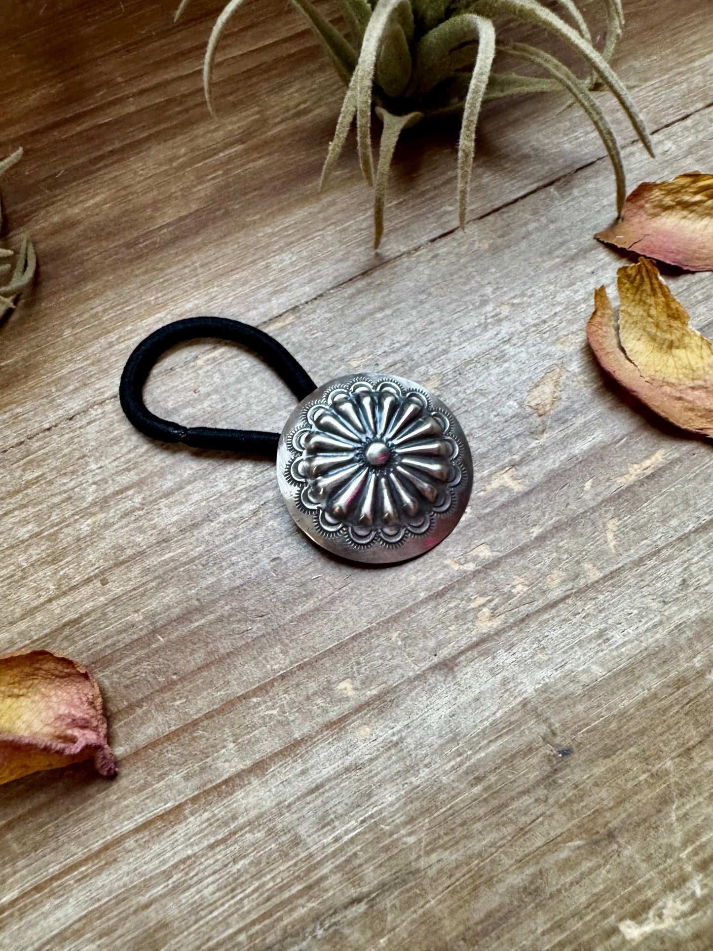 Handmade sterling silver hair tie with a detailed stamped concho design. Each piece is unique due to individual stamping. Western style accessory, made in the USA. Curated by The Bijoux FAB.