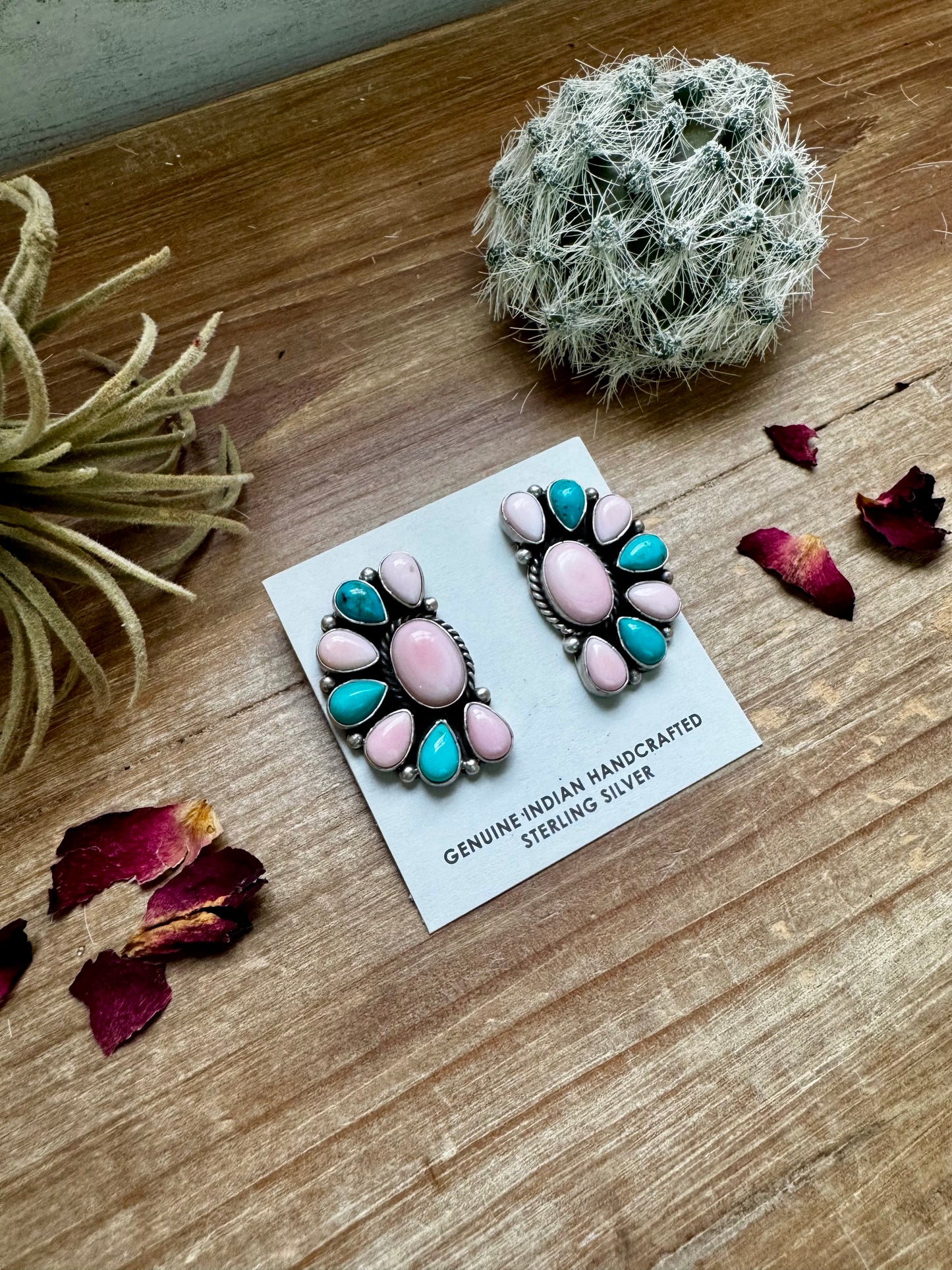 Handcrafted half cluster earrings with a dominant pink conch center surrounded by Kingman turquoise in a “Cotton Candy” color combo. Set in sterling silver, stamped E. Richards. Post backs placed at the top. Made in the USA. Each pair is one of a kind. Curated by The Bijoux FAB.