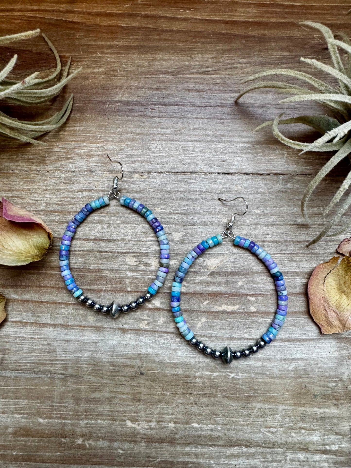 2-inch hoop earrings featuring 4mm sterling silver pearls, sterling silver saucer beads, and 2x4mm Purple Dolomite Heishi. Finished with silver-plated hooks. Every pair has slightly unique color variation. Handmade in the USA by The Bijoux FAB.