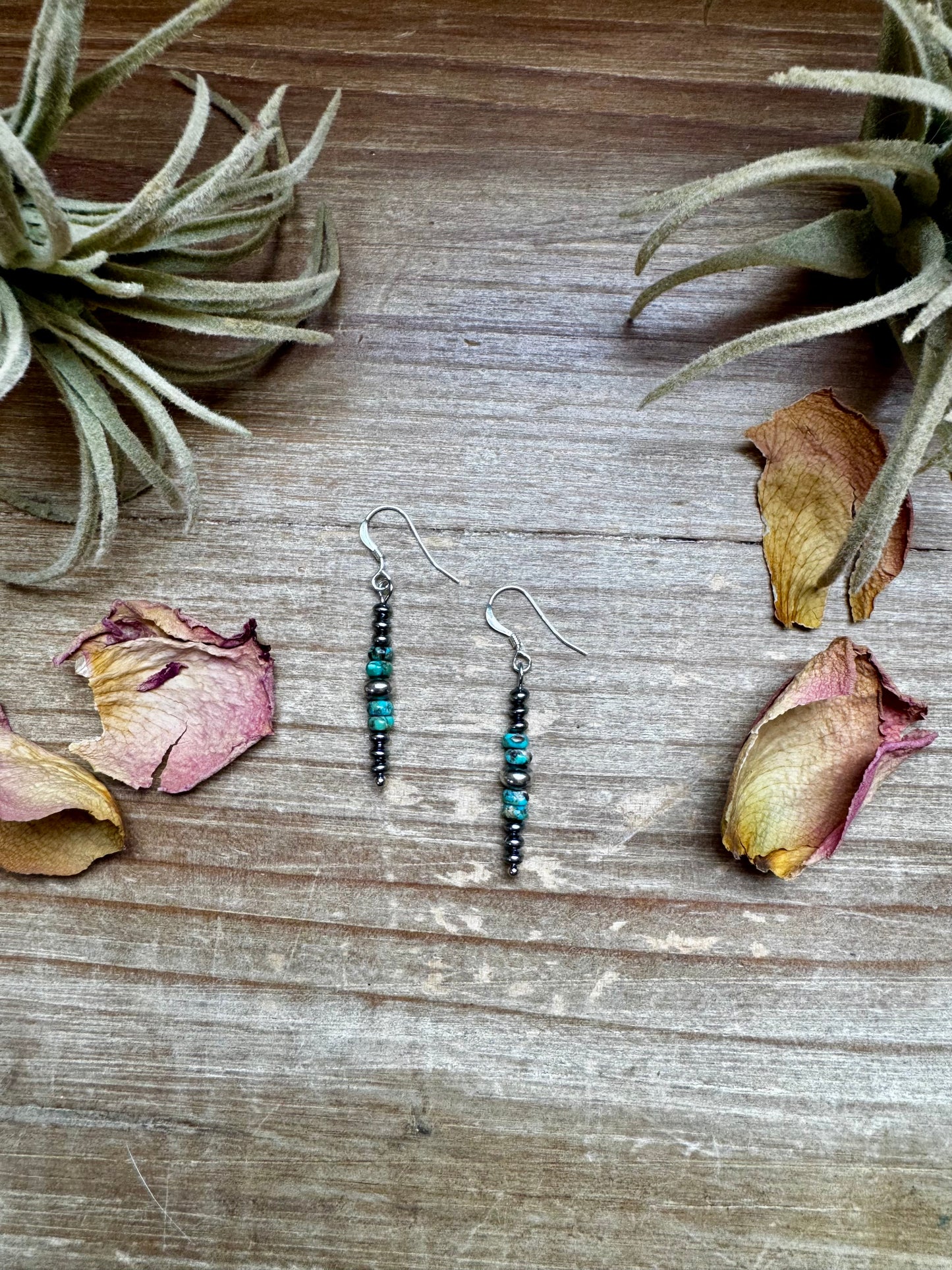 Close-up of handmade turquoise rondelle earrings with sterling silver beads and hooks, under 1.5 inches long