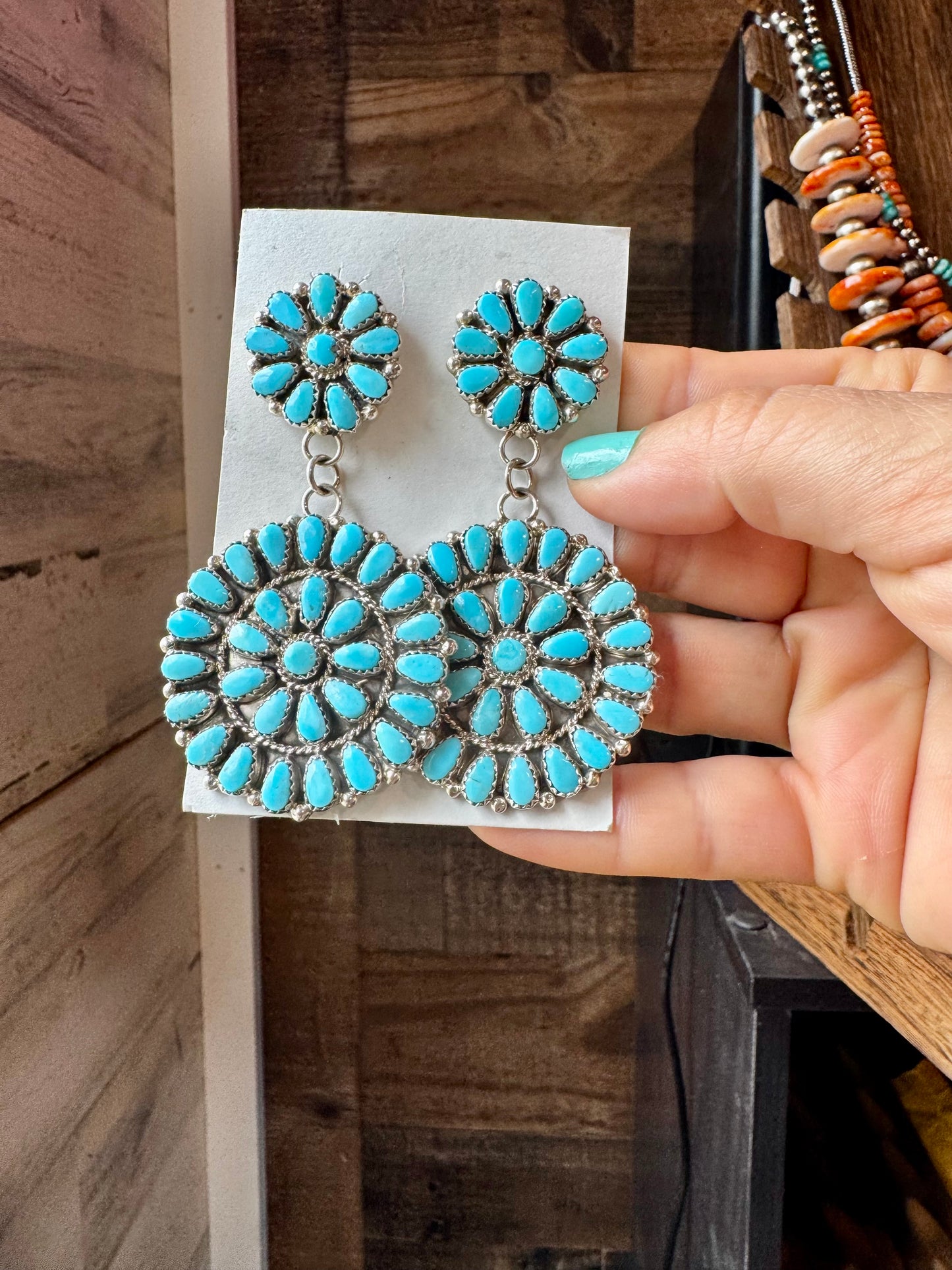 Handcrafted sterling silver cluster dangle earrings featuring genuine Sleeping Beauty turquoise stones. Post backs placed at the top for a secure drape. Artist-stamped and made in the USA. One of a kind. Curated by The Bijoux FAB.