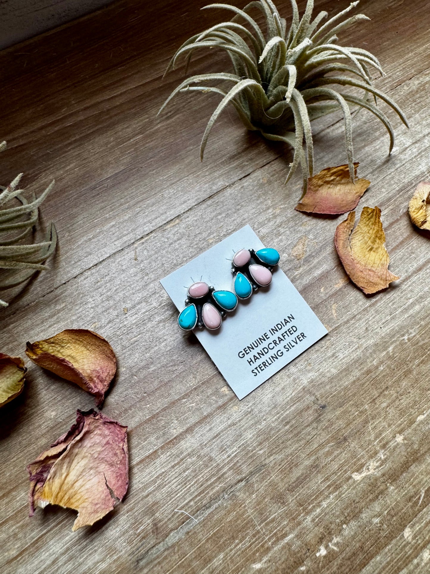 Handcrafted sterling silver stud earrings featuring genuine Kingman turquoise and pink conch stones. Stamped by artist Marcella James. Made in the USA. Each pair is naturally unique. Curated by The Bijoux FAB.