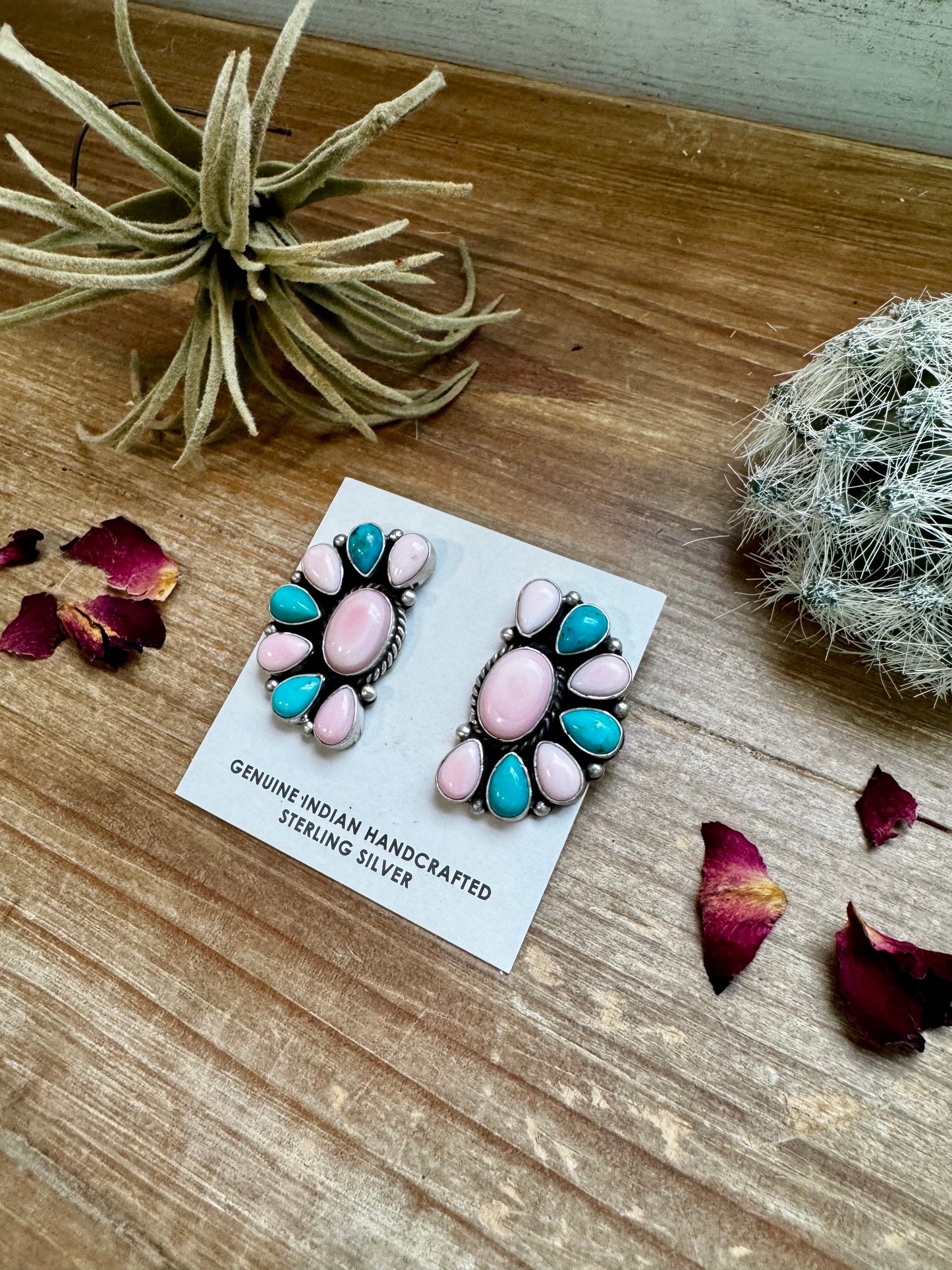 Handcrafted half cluster earrings with a dominant pink conch center surrounded by Kingman turquoise in a “Cotton Candy” color combo. Set in sterling silver, stamped E. Richards. Post backs placed at the top. Made in the USA. Each pair is one of a kind. Curated by The Bijoux FAB.