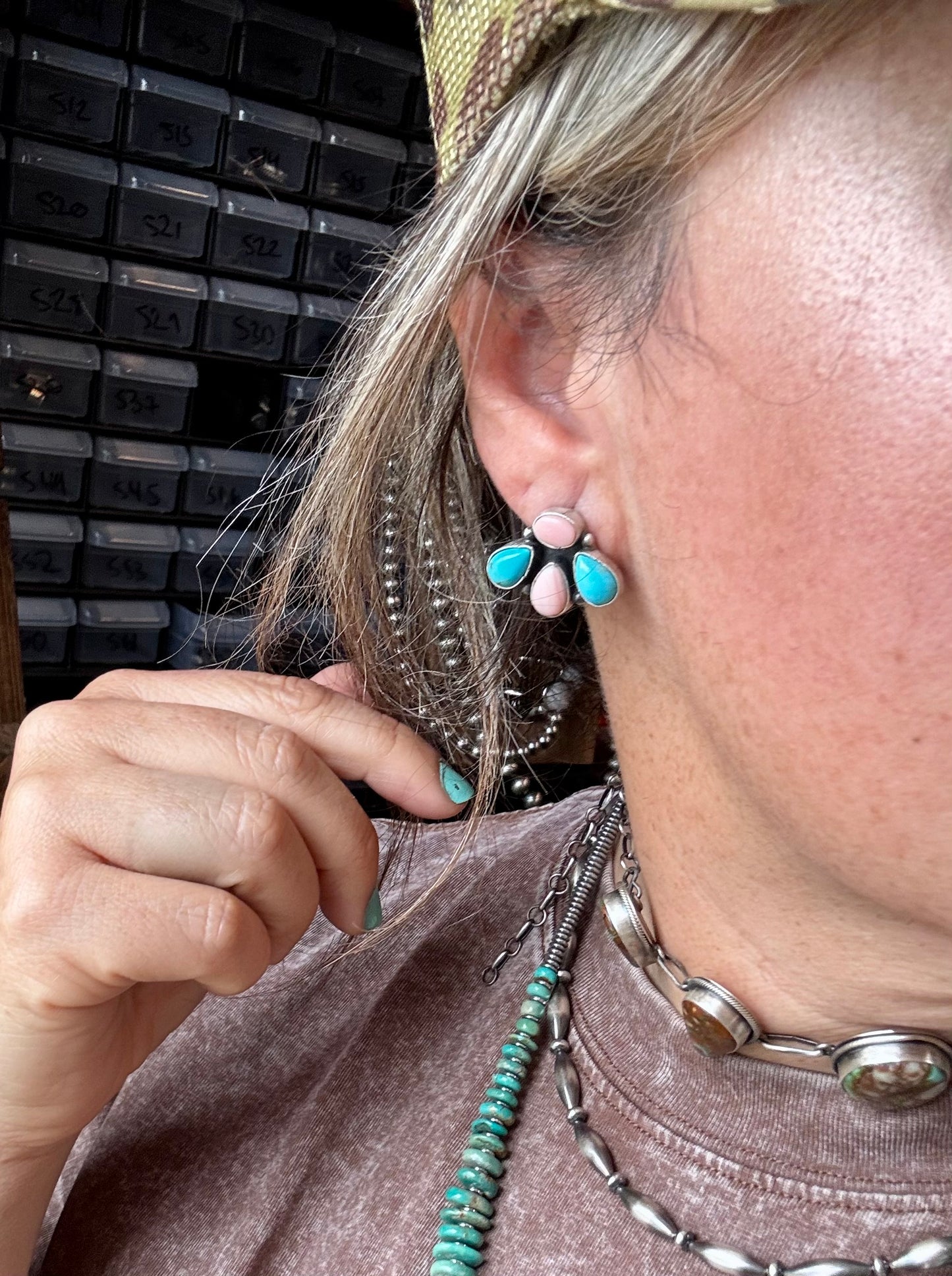 Handcrafted sterling silver stud earrings featuring genuine Kingman turquoise and pink conch stones. Stamped by artist Marcella James. Made in the USA. Each pair is naturally unique. Curated by The Bijoux FAB.