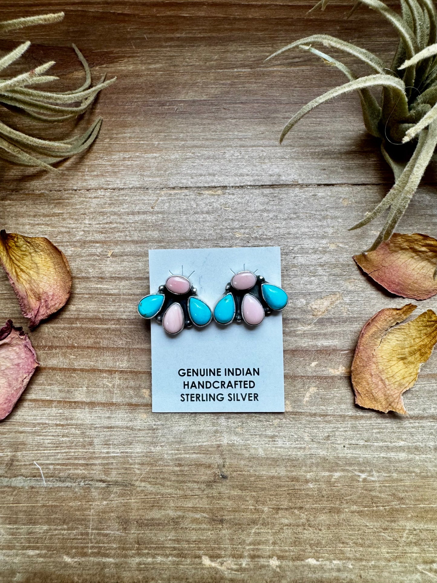 Handcrafted sterling silver stud earrings featuring genuine Kingman turquoise and pink conch stones. Stamped by artist Marcella James. Made in the USA. Each pair is naturally unique. Curated by The Bijoux FAB.