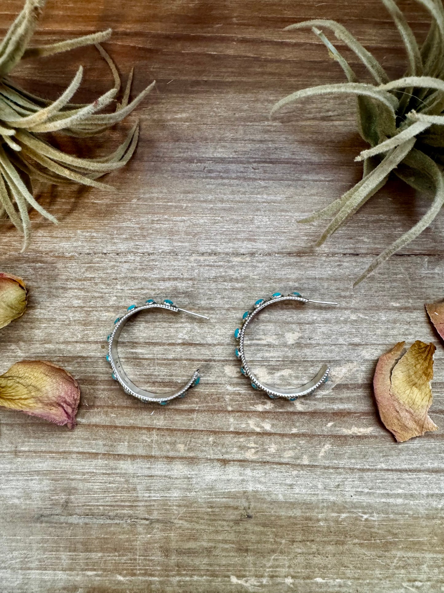 Handcrafted sterling silver hoop earrings with genuine Kingman turquoise in a snake eye design. Post back closure. Stamped FY. Each pair is unique in color and matrix. Made in the USA and curated by The Bijoux FAB.
