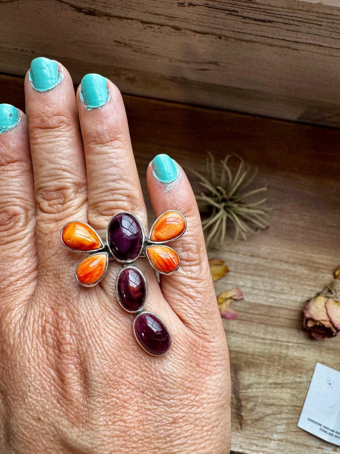 Handcrafted sterling silver dragonfly ring featuring purple and orange spiny oyster stones. Stamped ZIA and made in the USA. Adjustable fit and full of playful personality. Curated by The Bijoux FAB.