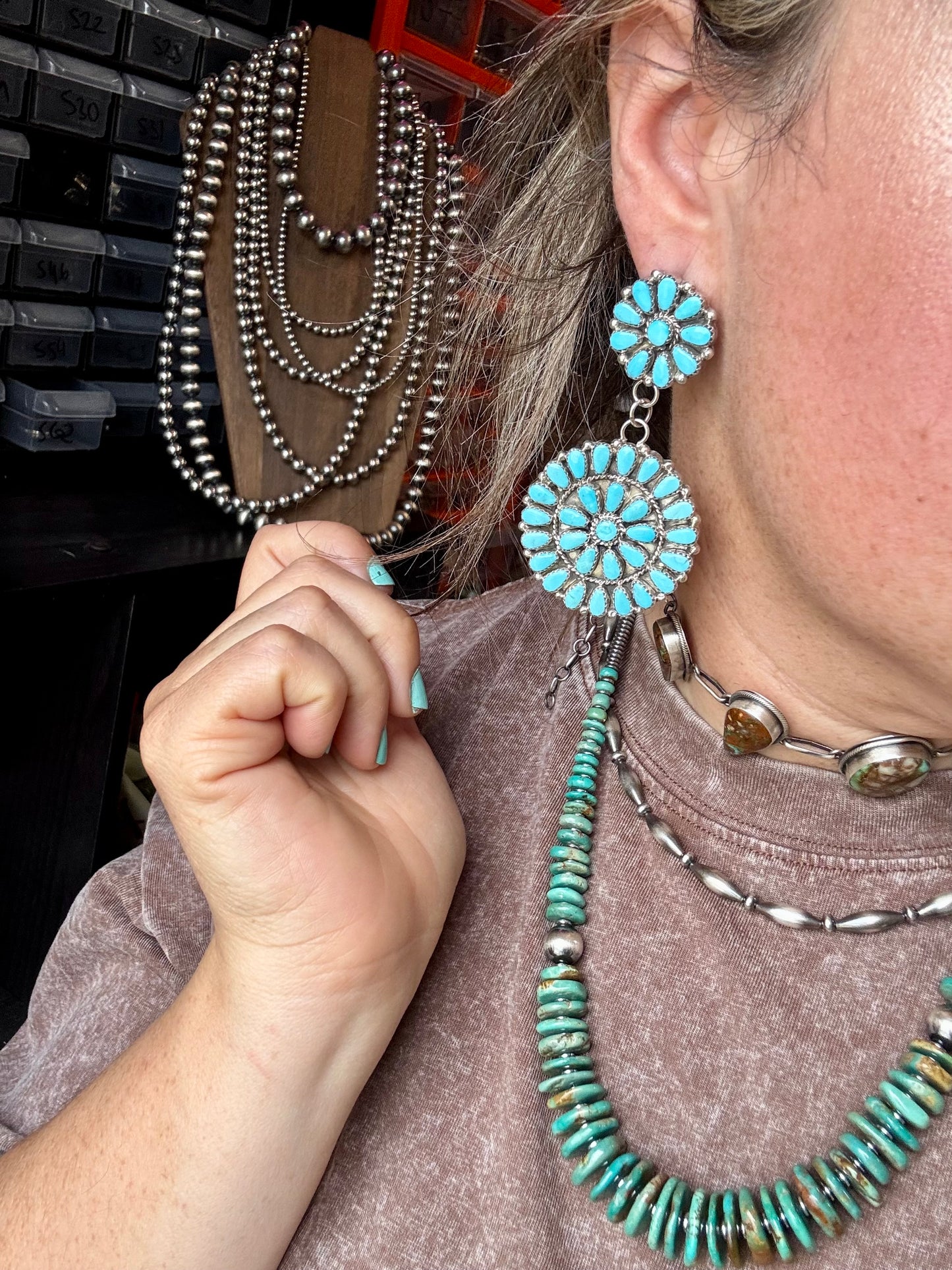 Handcrafted sterling silver cluster dangle earrings featuring genuine Sleeping Beauty turquoise stones. Post backs placed at the top for a secure drape. Artist-stamped and made in the USA. One of a kind. Curated by The Bijoux FAB.