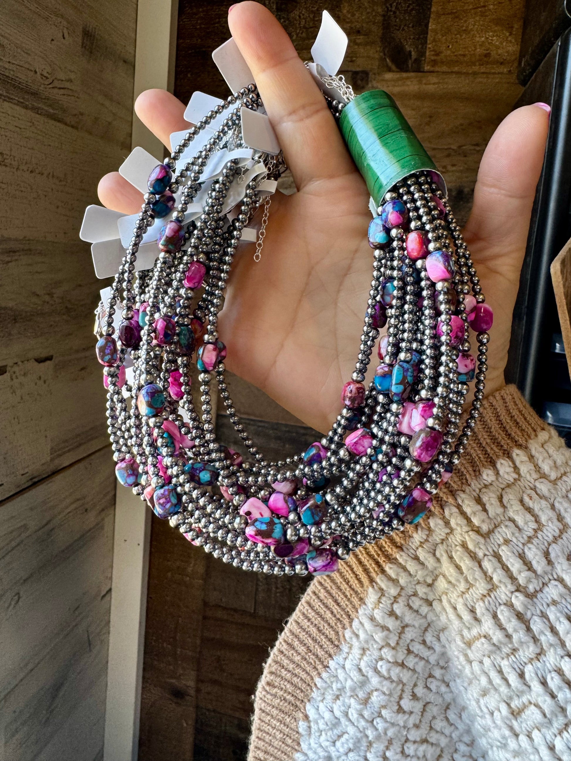 Handmade 14-inch necklace featuring pink-dyed real turquoise stones with 3mm and 4mm sterling silver pearls. Includes a 2-inch sterling silver extender. Each piece has unique color and shape variations. Made in the USA by The Bijoux FA