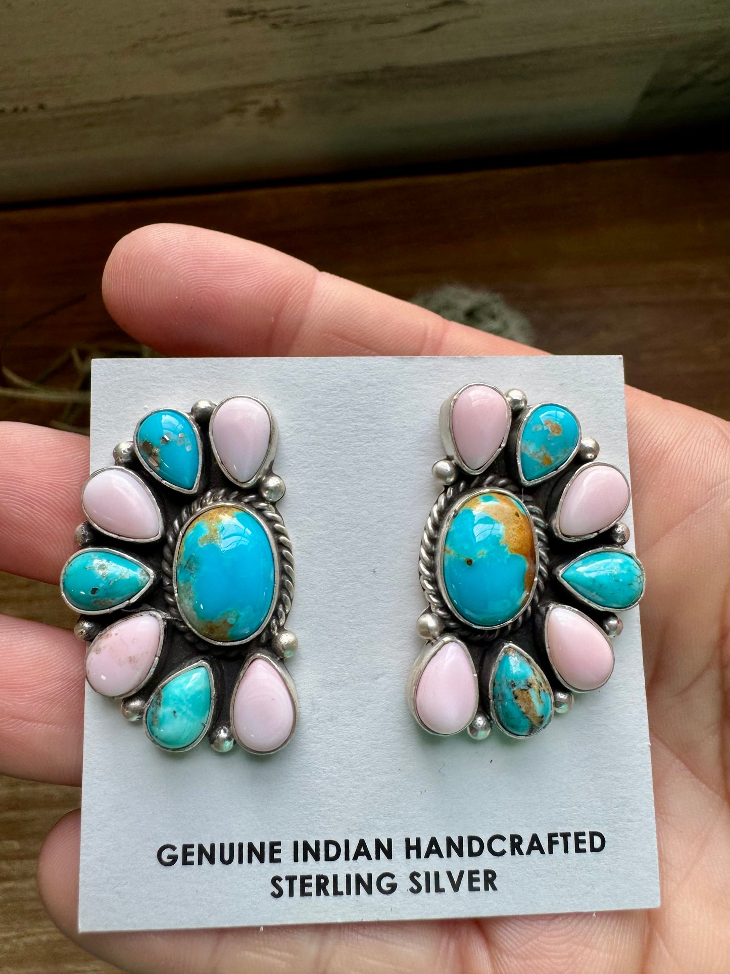 Handcrafted sterling silver half cluster earrings featuring a mix of pink conch and Kingman turquoise in a bold “Cotton Candy” color combo. Stamped E. Richards with post backs placed at the top. Made in the USA. Each pair is unique. Curated by The Bijoux FAB.