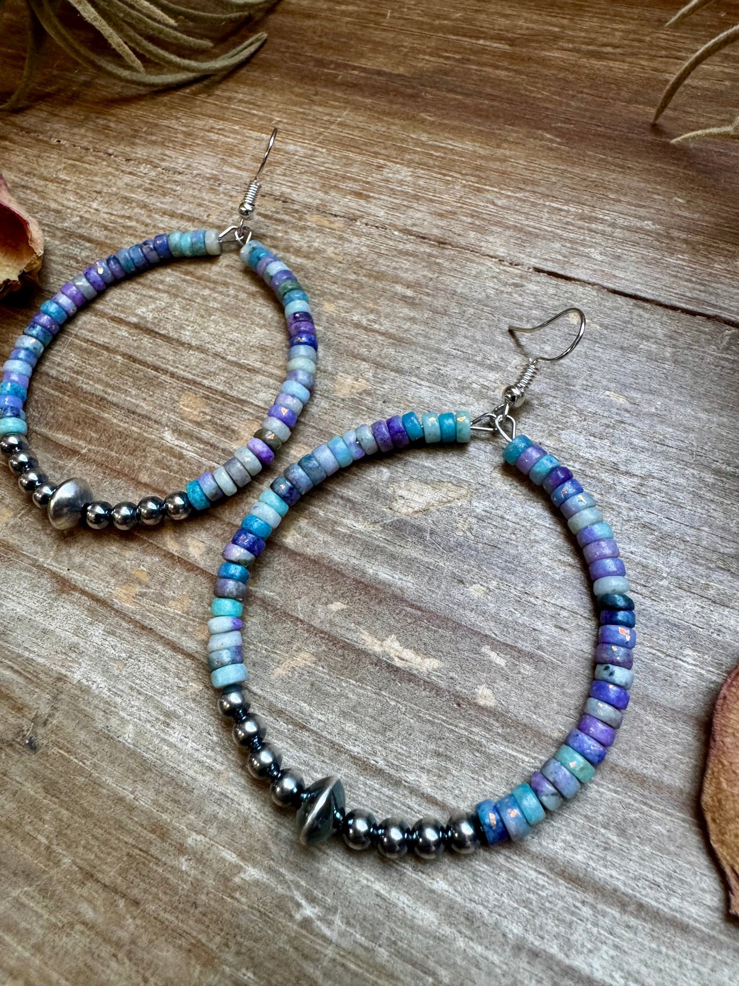 2-inch hoop earrings featuring 4mm sterling silver pearls, sterling silver saucer beads, and 2x4mm Purple Dolomite Heishi. Finished with silver-plated hooks. Every pair has slightly unique color variation. Handmade in the USA by The Bijoux FAB.