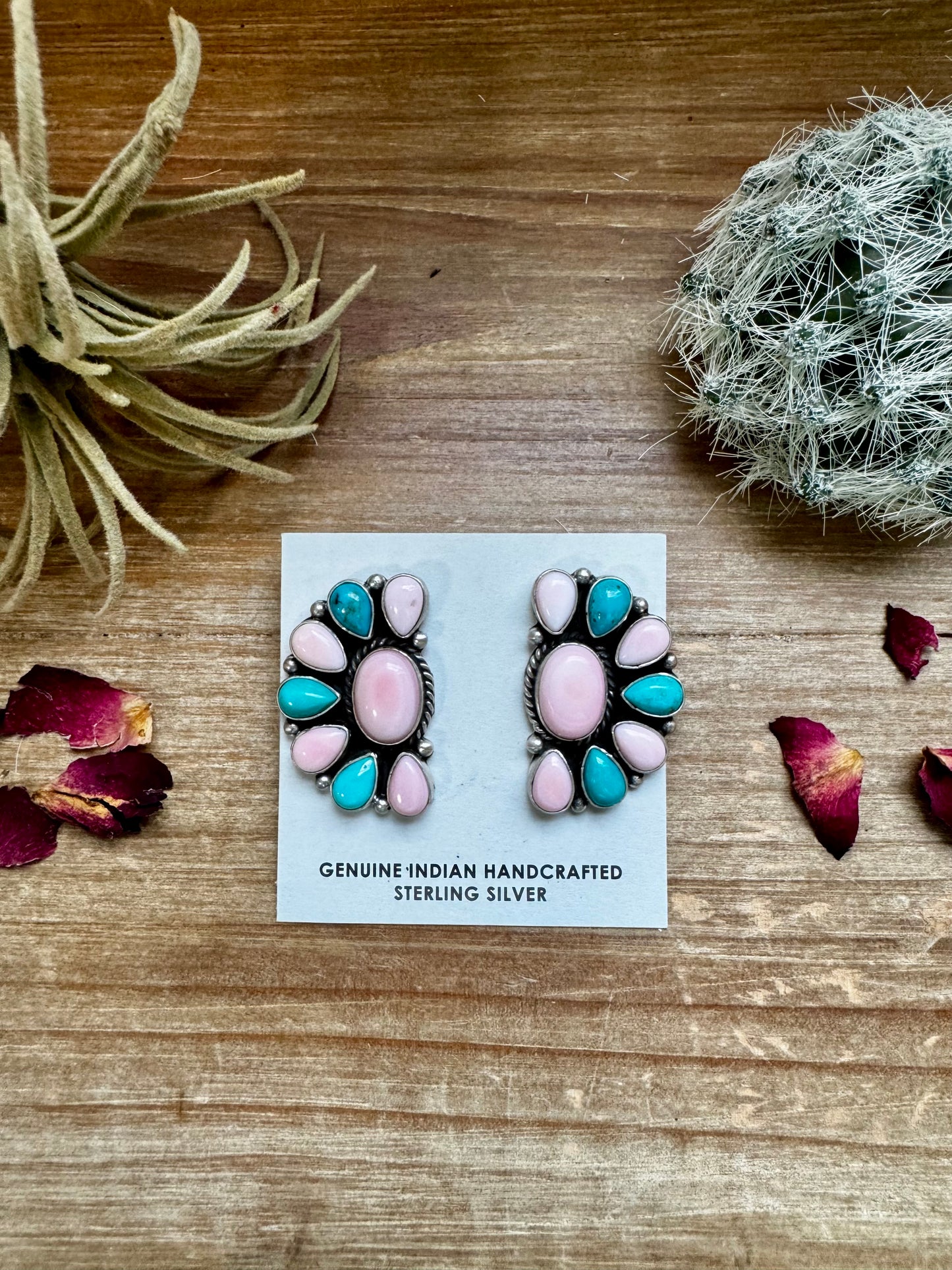 Handcrafted half cluster earrings with a dominant pink conch center surrounded by Kingman turquoise in a “Cotton Candy” color combo. Set in sterling silver, stamped E. Richards. Post backs placed at the top. Made in the USA. Each pair is one of a kind. Curated by The Bijoux FAB.