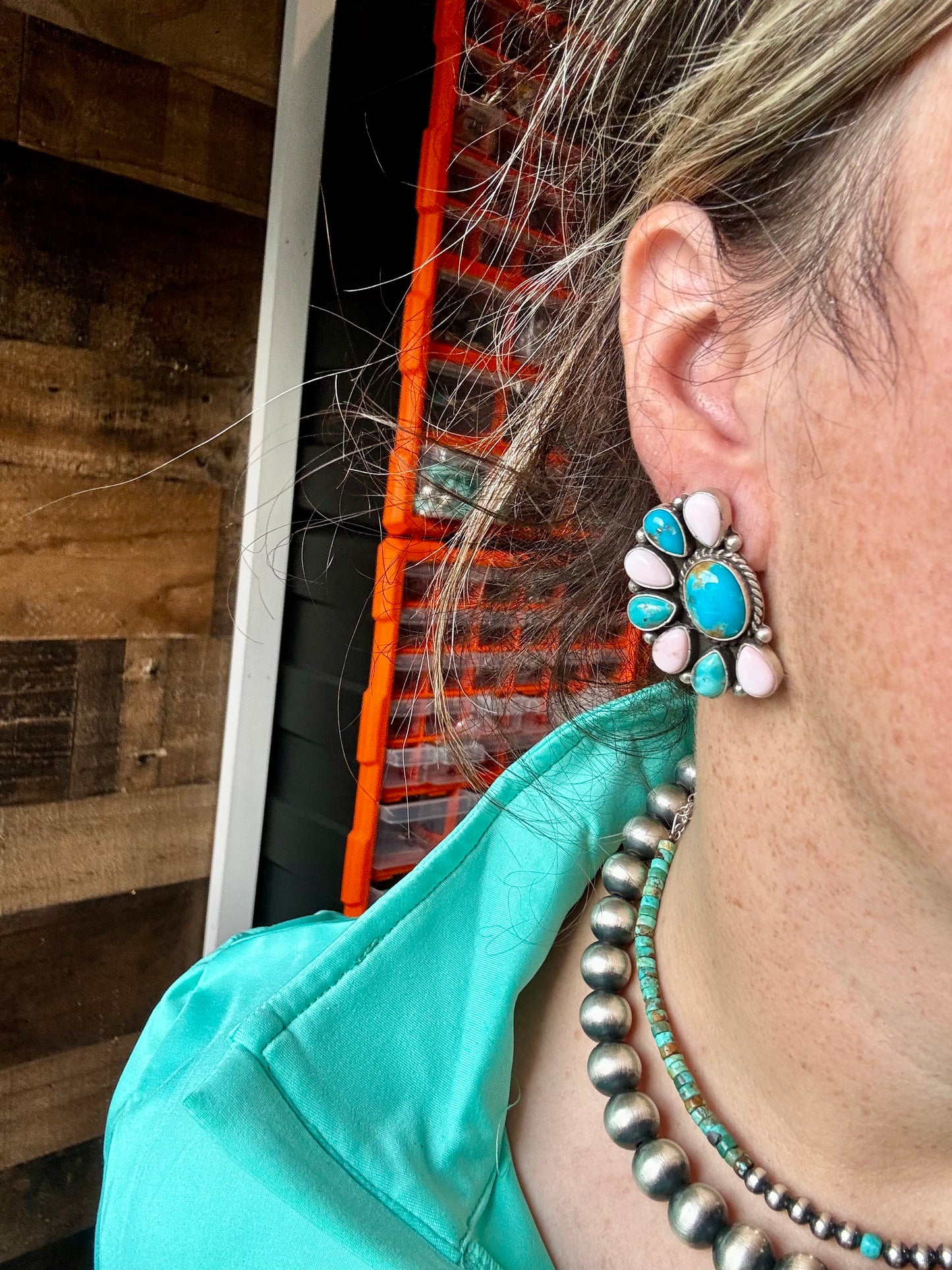 Handcrafted sterling silver half cluster earrings featuring a mix of pink conch and Kingman turquoise in a bold “Cotton Candy” color combo. Stamped E. Richards with post backs placed at the top. Made in the USA. Each pair is unique. Curated by The Bijoux FAB.