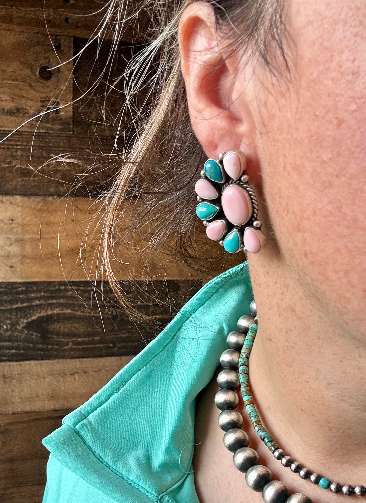 Handcrafted half cluster earrings with a dominant pink conch center surrounded by Kingman turquoise in a “Cotton Candy” color combo. Set in sterling silver, stamped E. Richards. Post backs placed at the top. Made in the USA. Each pair is one of a kind. Curated by The Bijoux FAB.