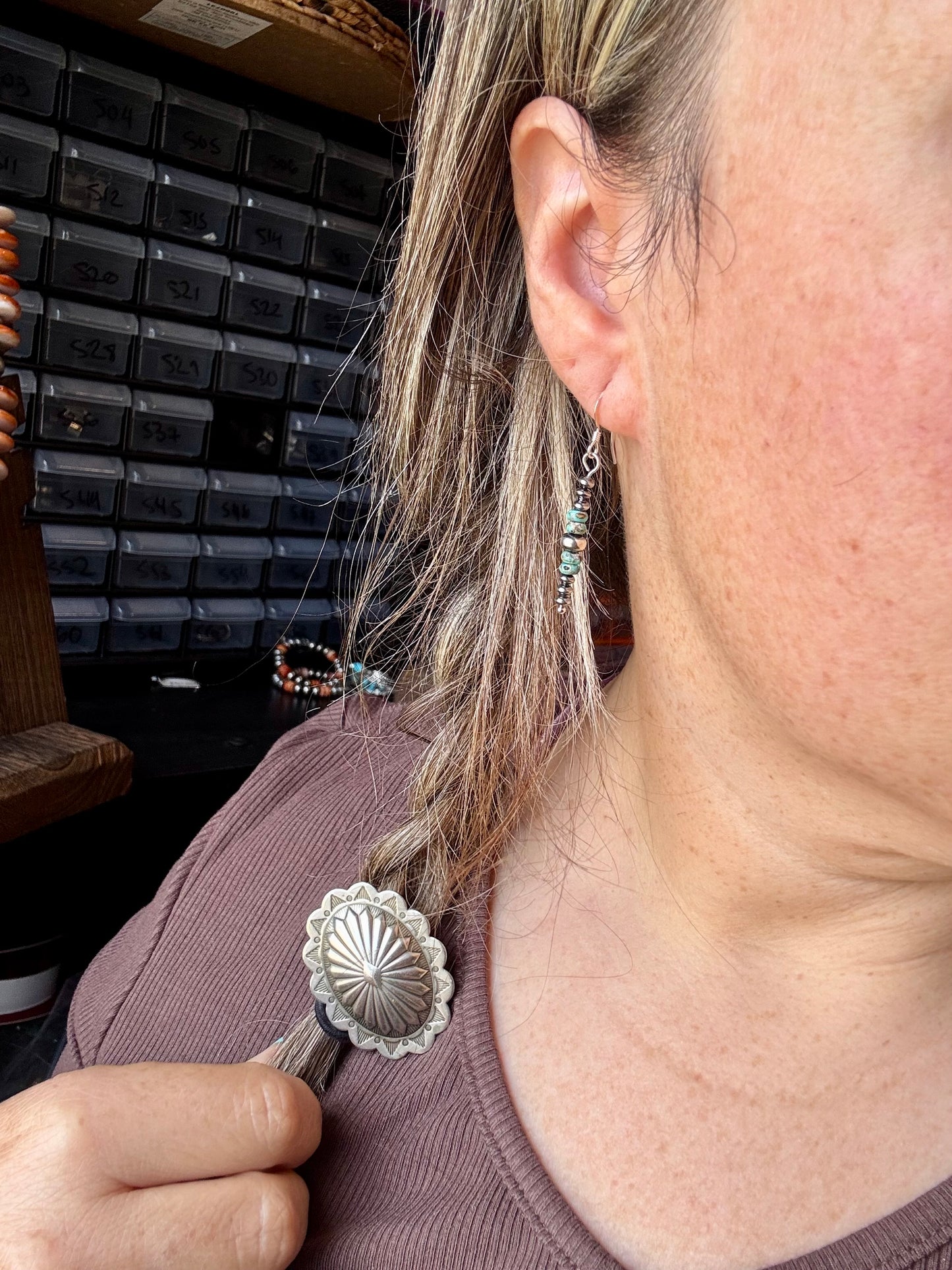 Close-up of handmade turquoise rondelle earrings with sterling silver beads and hooks, under 1.5 inches long