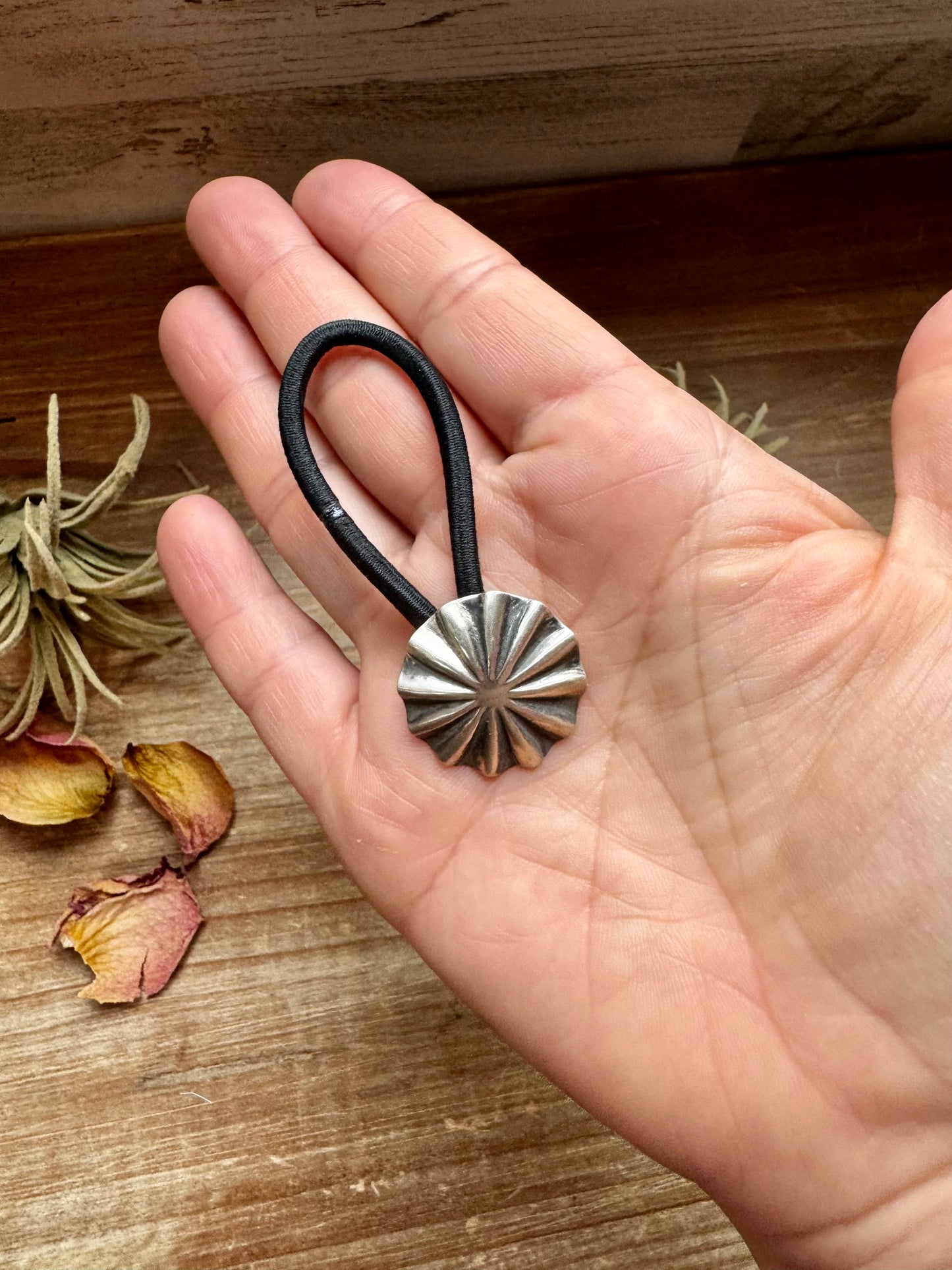 Small sterling silver hair tie featuring a hand-stamped concho design. Lightweight, durable, and stamped STERLING. Handmade in the USA. Each pattern is slightly different. Curated by The Bijoux FAB.
