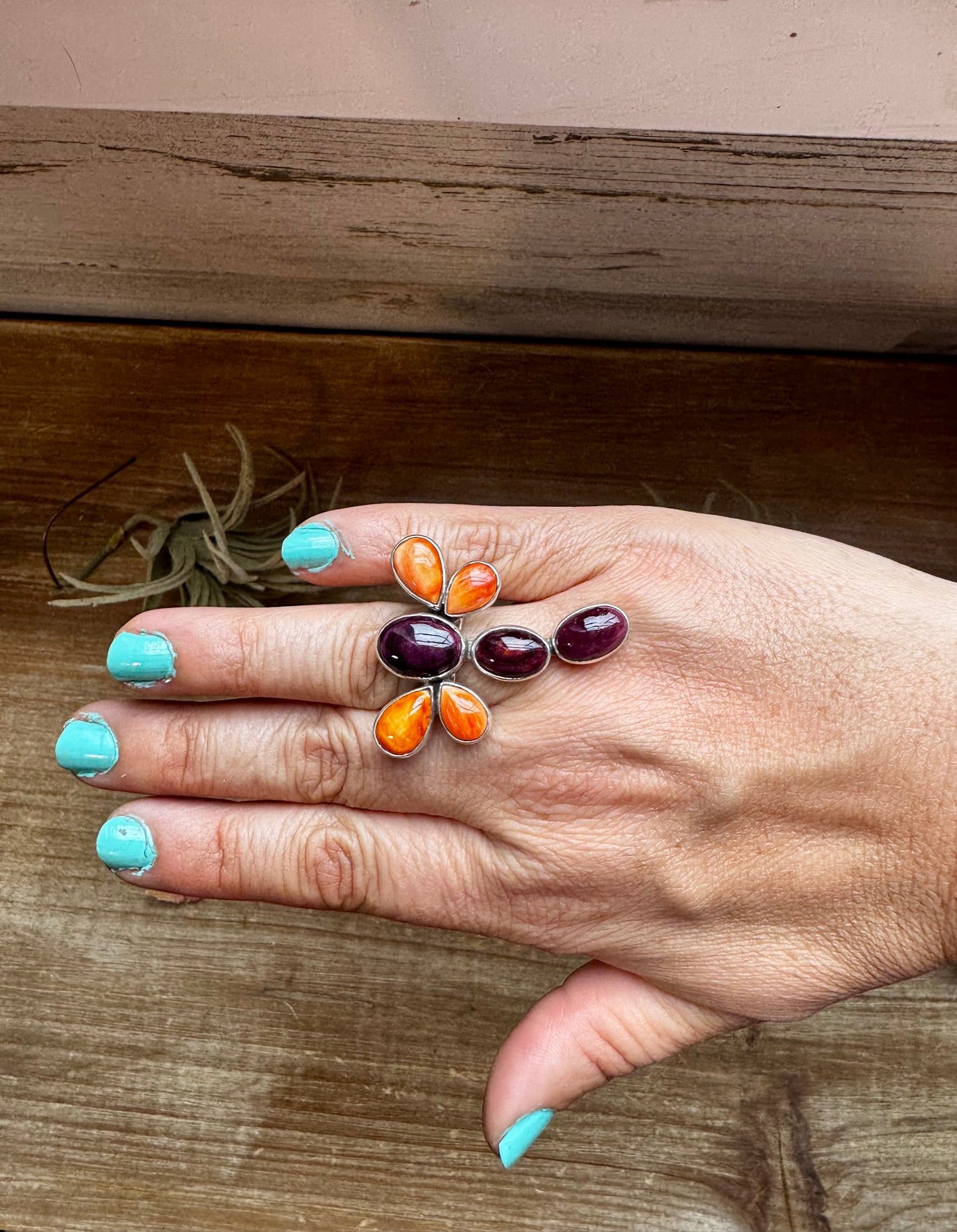 Handcrafted sterling silver dragonfly ring featuring purple and orange spiny oyster stones. Stamped ZIA and made in the USA. Adjustable fit and full of playful personality. Curated by The Bijoux FAB.