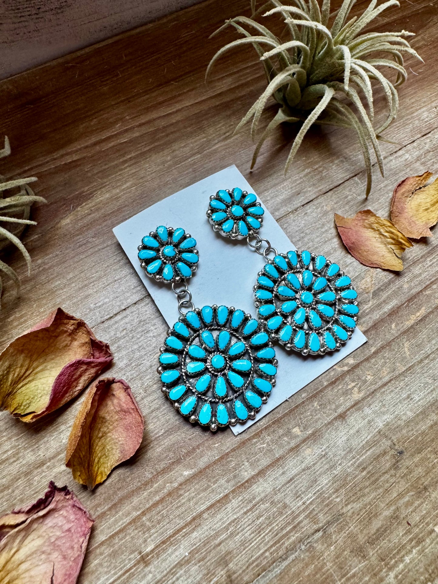 Handcrafted sterling silver cluster dangle earrings featuring genuine Sleeping Beauty turquoise stones. Post backs placed at the top for a secure drape. Artist-stamped and made in the USA. One of a kind. Curated by The Bijoux FAB.