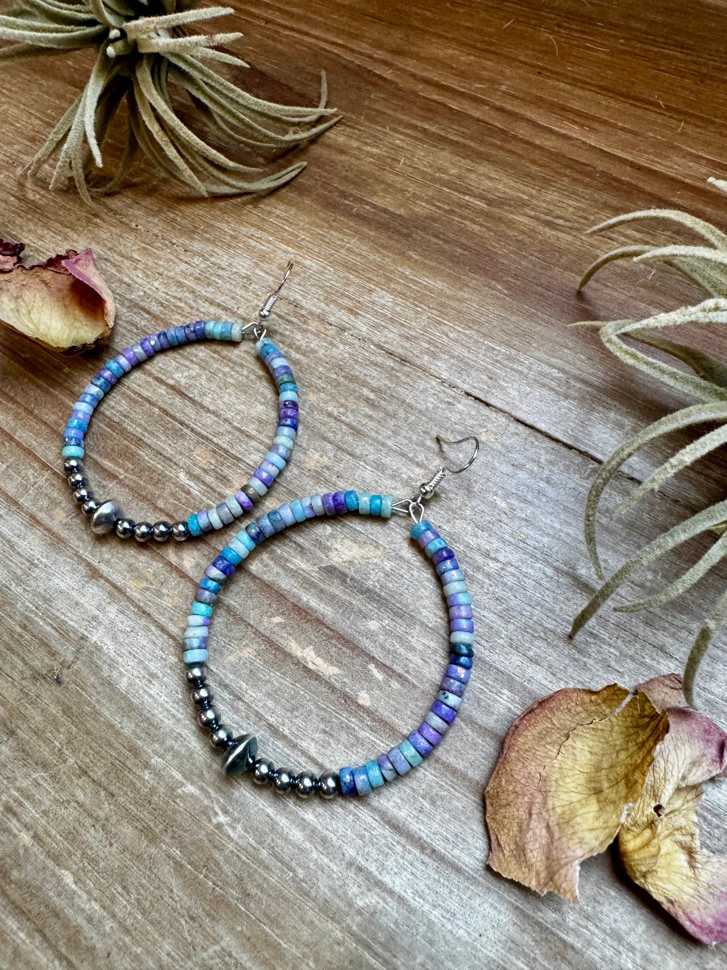 2-inch hoop earrings featuring 4mm sterling silver pearls, sterling silver saucer beads, and 2x4mm Purple Dolomite Heishi. Finished with silver-plated hooks. Every pair has slightly unique color variation. Handmade in the USA by The Bijoux FAB.