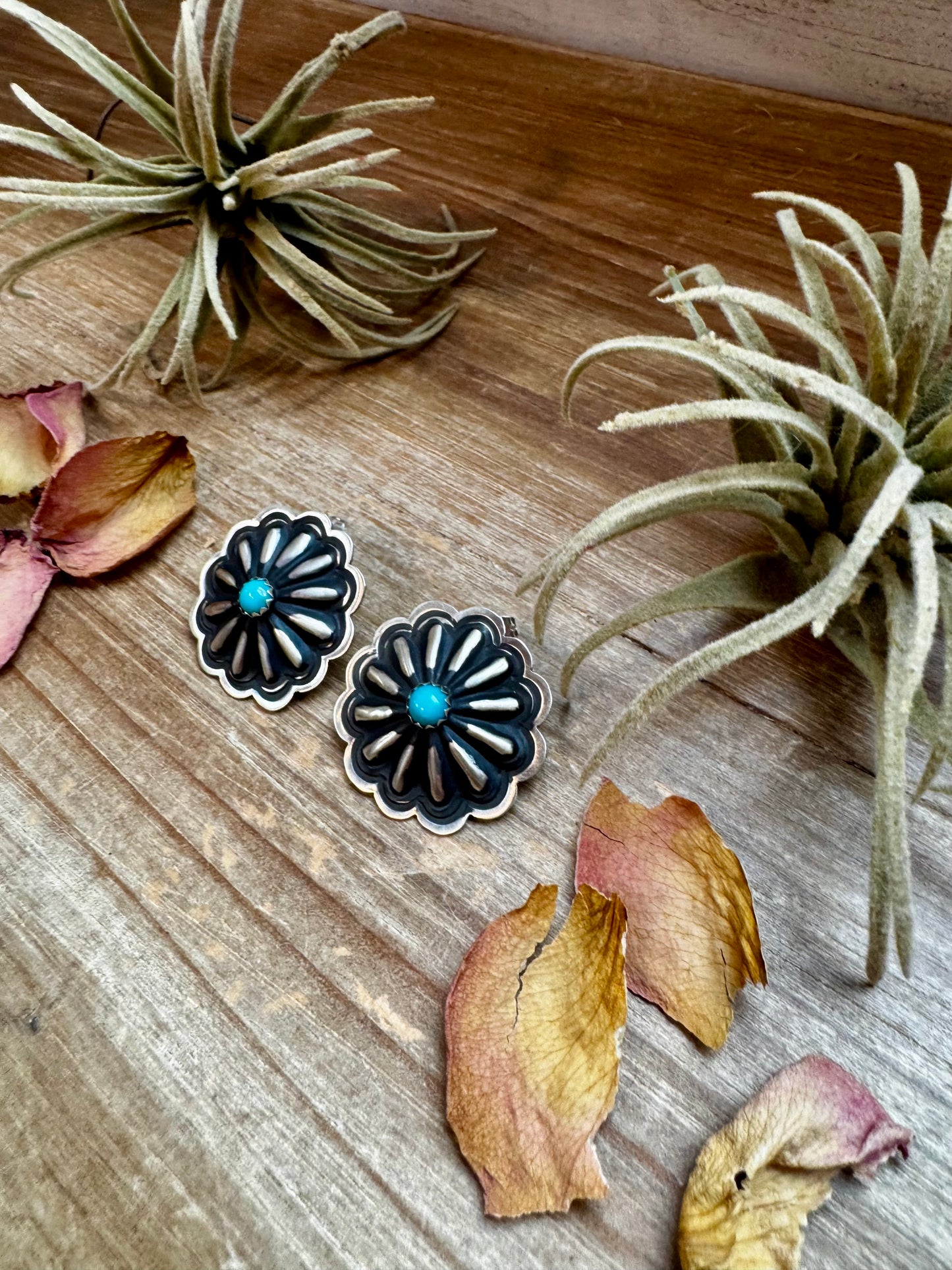 Large handcrafted concho stud earrings featuring genuine turquoise stones set in detailed sterling silver. Made in the USA. Lightweight and naturally unique. Curated by The Bijoux FAB.
