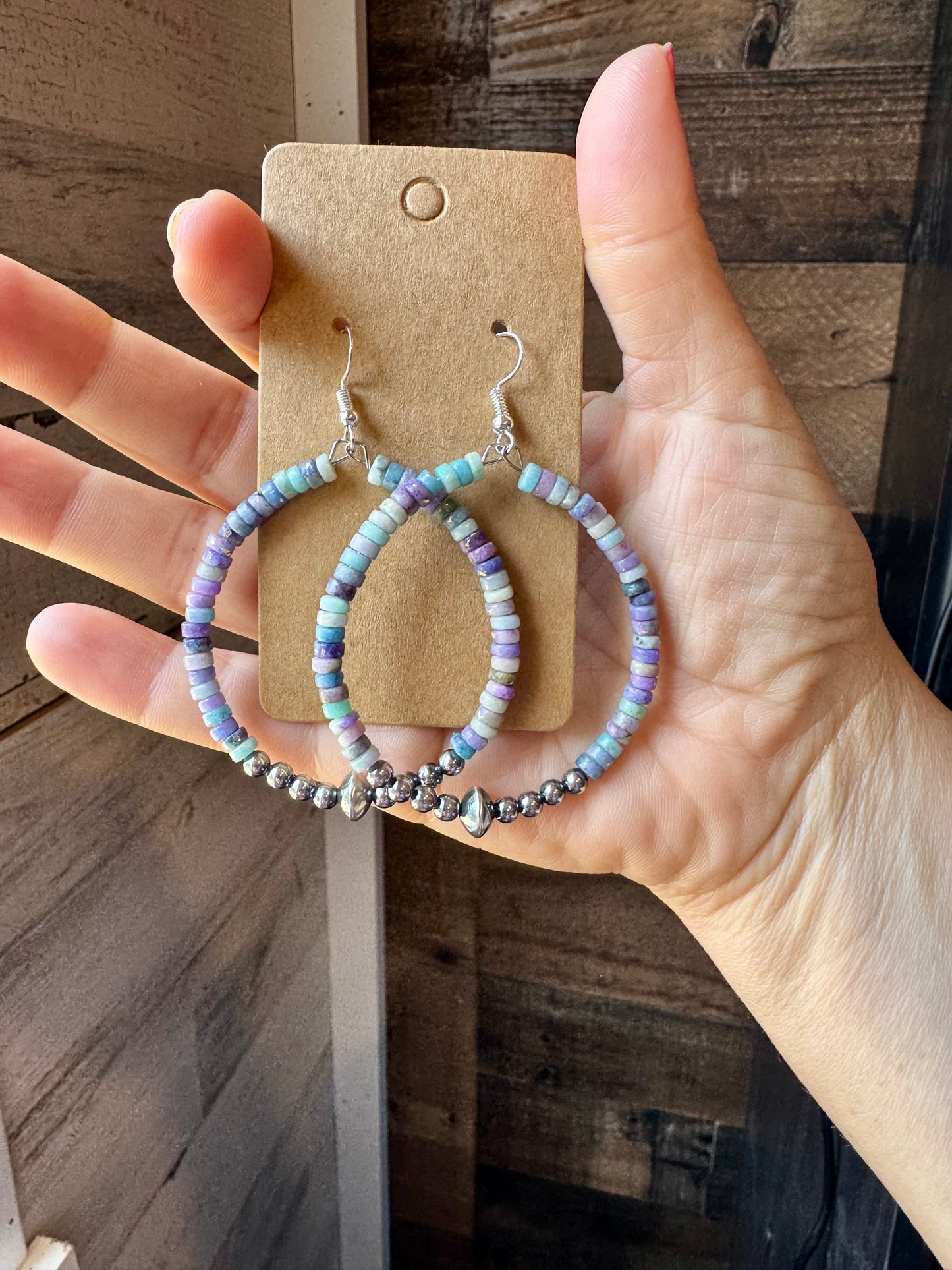 2-inch hoop earrings featuring 4mm sterling silver pearls, sterling silver saucer beads, and 2x4mm Purple Dolomite Heishi. Finished with silver-plated hooks. Every pair has slightly unique color variation. Handmade in the USA by The Bijoux FAB.