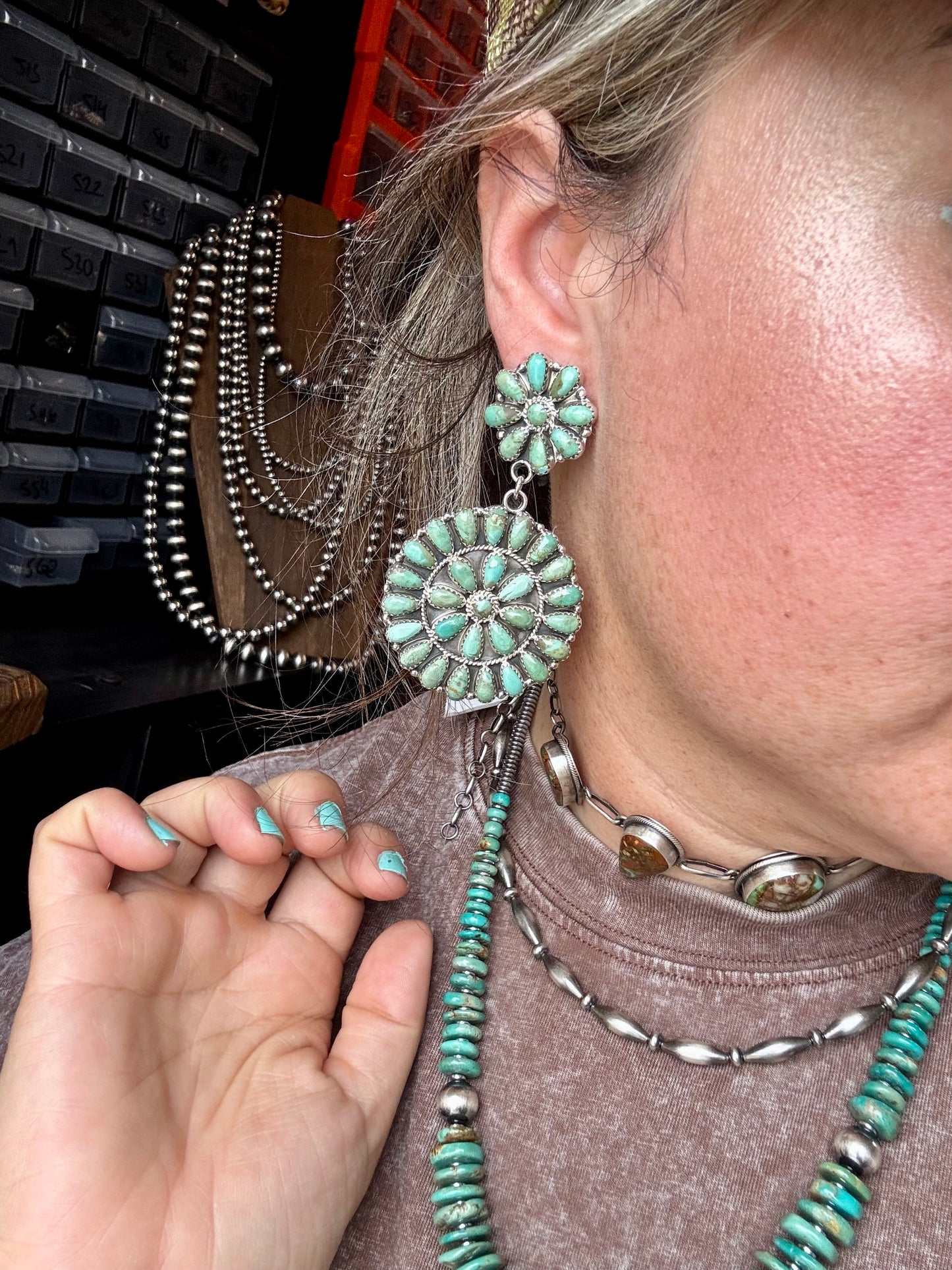 Handcrafted cluster dangle earrings featuring genuine Kingman turquoise stones set in sterling silver with a secure post back. Stamped OM. Made in the USA. Each pair is naturally unique. Curated by The Bijoux FAB.