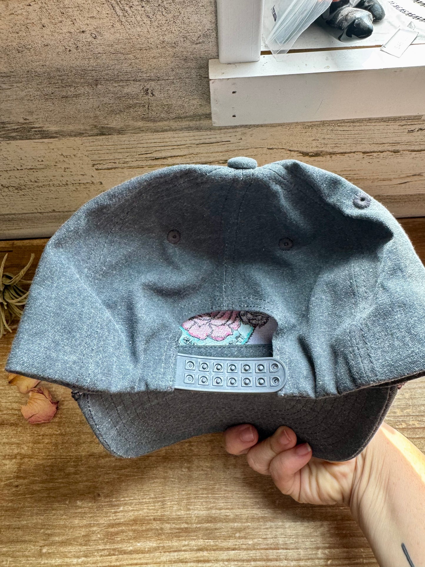 The Bijoux FAB baseball cap with embroidered logo, made in China and embroidered in Paris, Texas, adjustable fit