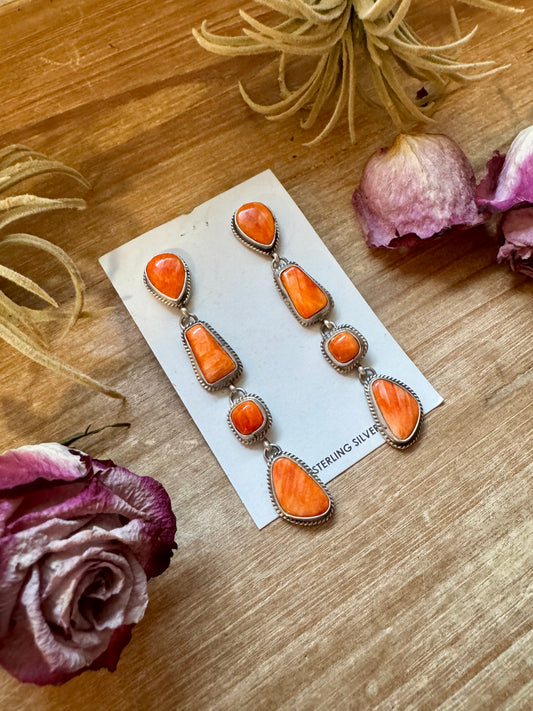 Sterling silver stud and dangle earrings with four spiny oyster charms, handmade by Navajo artist Marcella James