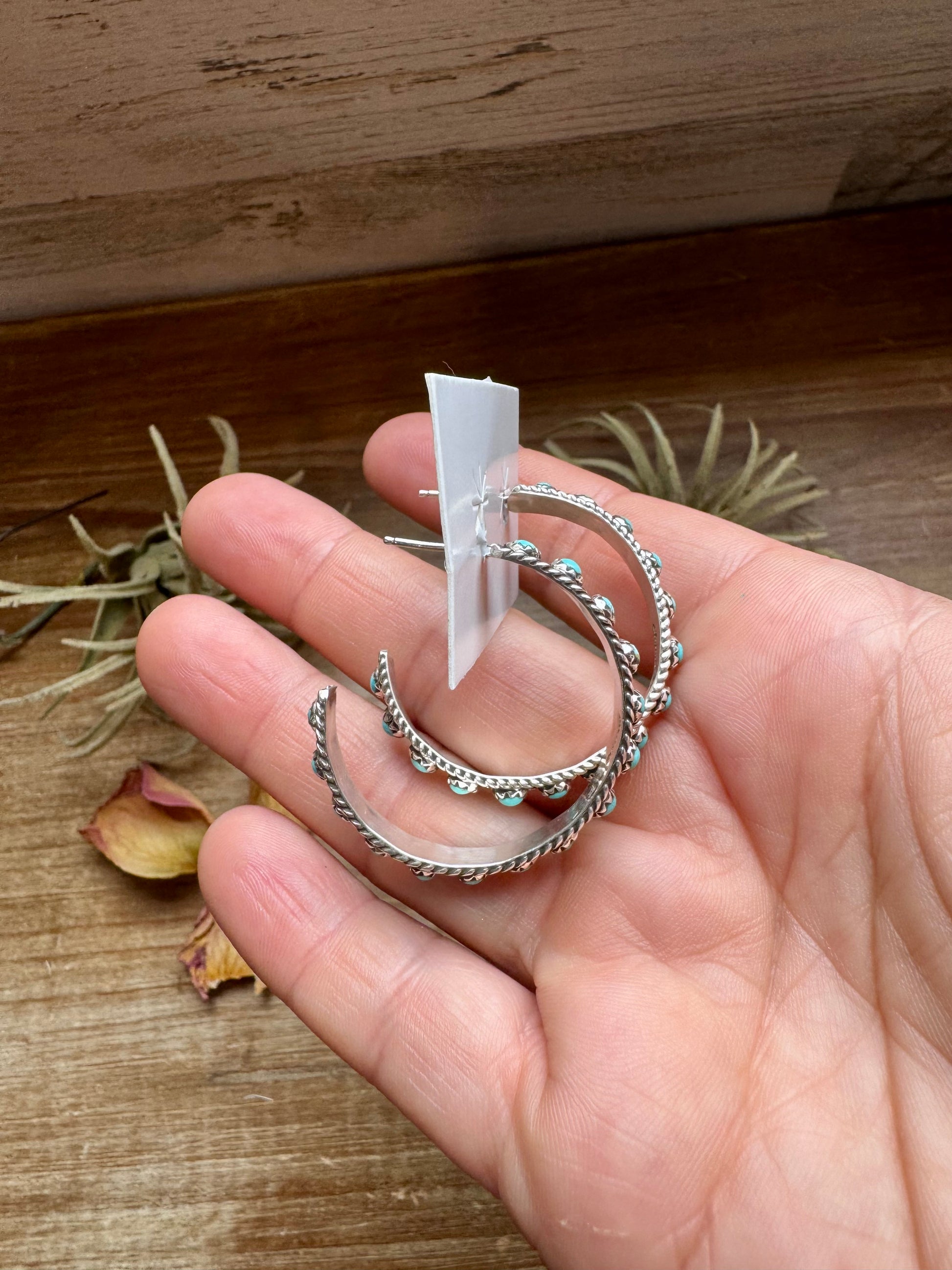 Handcrafted Snake Eye hoop earrings featuring rows of genuine Kingman turquoise stones set in solid sterling silver. Stamped FY and made in the USA. Lightweight and bold. Curated by The Bijoux FAB.