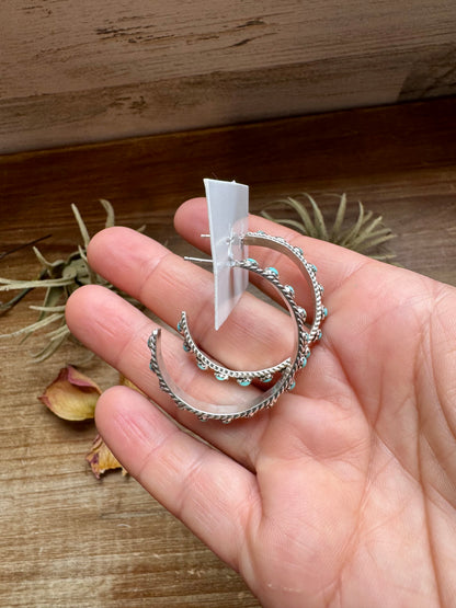 Handcrafted Snake Eye hoop earrings featuring rows of genuine Kingman turquoise stones set in solid sterling silver. Stamped FY and made in the USA. Lightweight and bold. Curated by The Bijoux FAB.