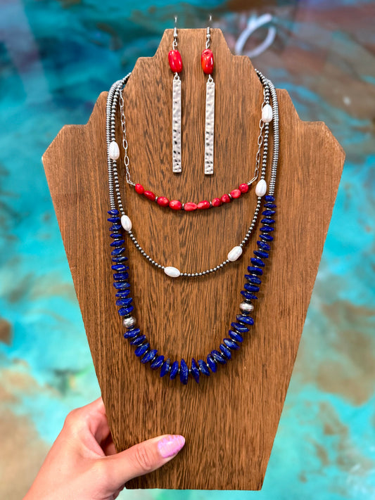 Red white and blue layered necklace stack with dyed coral, freshwater pearls, lapis beads, and matching earrings handmade in the USA by The Bijoux FAB