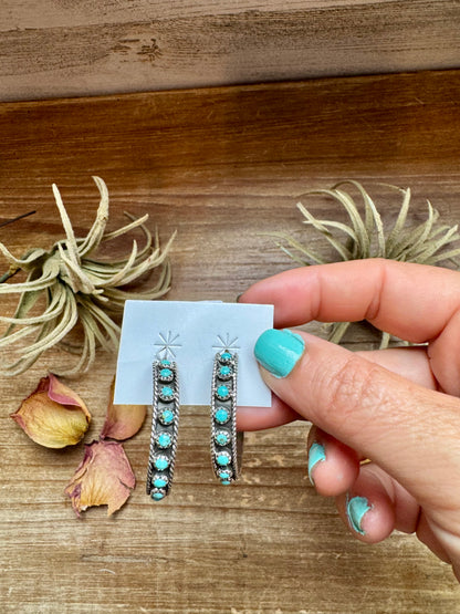 Handcrafted Snake Eye hoop earrings featuring rows of genuine Kingman turquoise stones set in solid sterling silver. Stamped FY and made in the USA. Lightweight and bold. Curated by The Bijoux FAB.