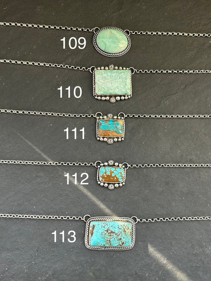 Sterling silver bar necklace with Royston turquoise and ribbon detail by artist Jason Ogg



