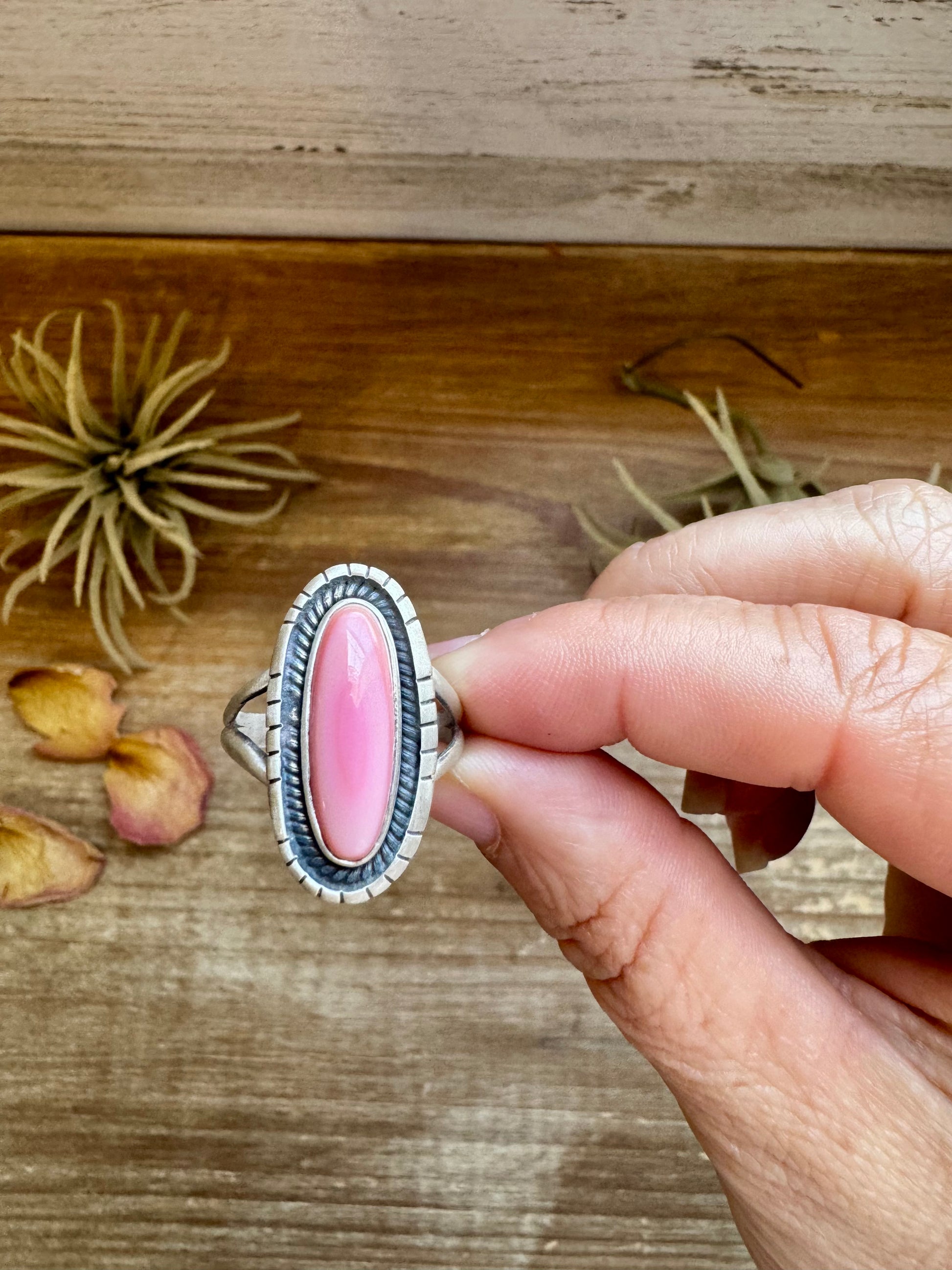 This pink conch ring features a soft, natural hue set in a sleek oval shape. Crafted in sterling silver, it’s a beautiful everyday piece that still makes a statement. Made in the USA (not by The Bijoux FAB), this ring is perfect for anyone who loves a clean, simple look with a pop of color.

Size 10
Sterling silver
Genuine pink conch
Oval shape design
Made in the USA
Not made by The Bijoux FAB