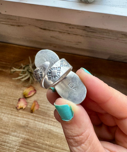 Handcrafted 2-stone ring featuring genuine turquoise and white buffalo set in solid sterling silver. Stamped BJA with an adjustable band. Made in the USA. Each piece is naturally unique. Curated by The Bijoux FAB.