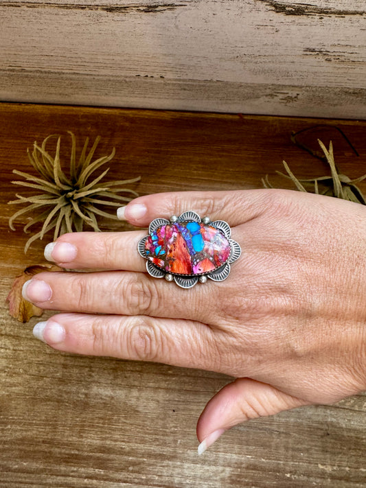 Adjustable sterling silver ring with pink dahlia oval stone, handmade by Navajo artist Tia Long, made in USA