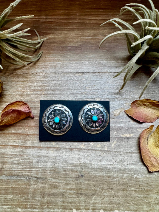 Handcrafted sterling silver concho earrings featuring genuine Kingman turquoise and unique hand-stamped details. Stamped STERLING and made in the USA. Each pair is slightly different. Curated by The Bijoux FAB.