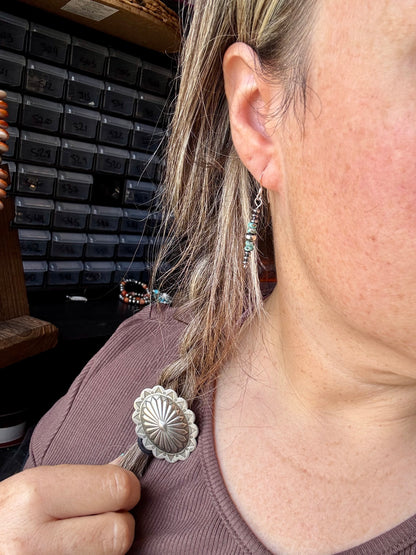 Close-up of handmade turquoise rondelle earrings with sterling silver beads and hooks, under 1.5 inches long