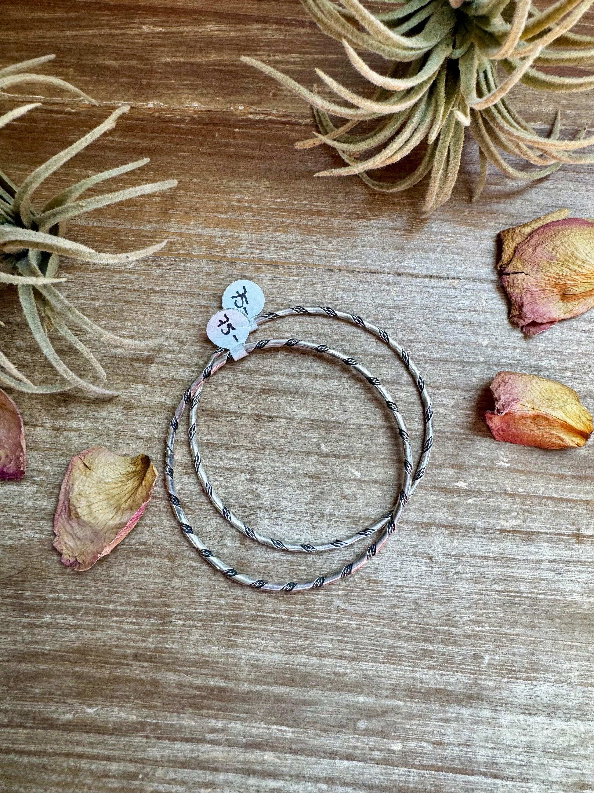 Native-made sterling silver bangle bracelets, each unique in pattern and finish, sold separately